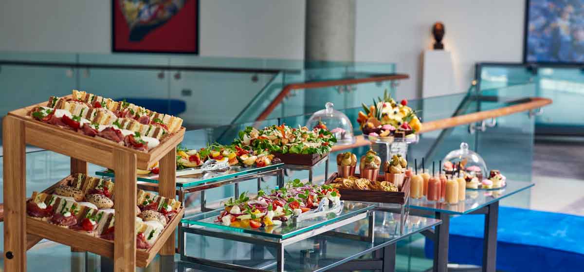 Buffet setup with gourmet appetizers for corporate event at The Lowry Hotel.