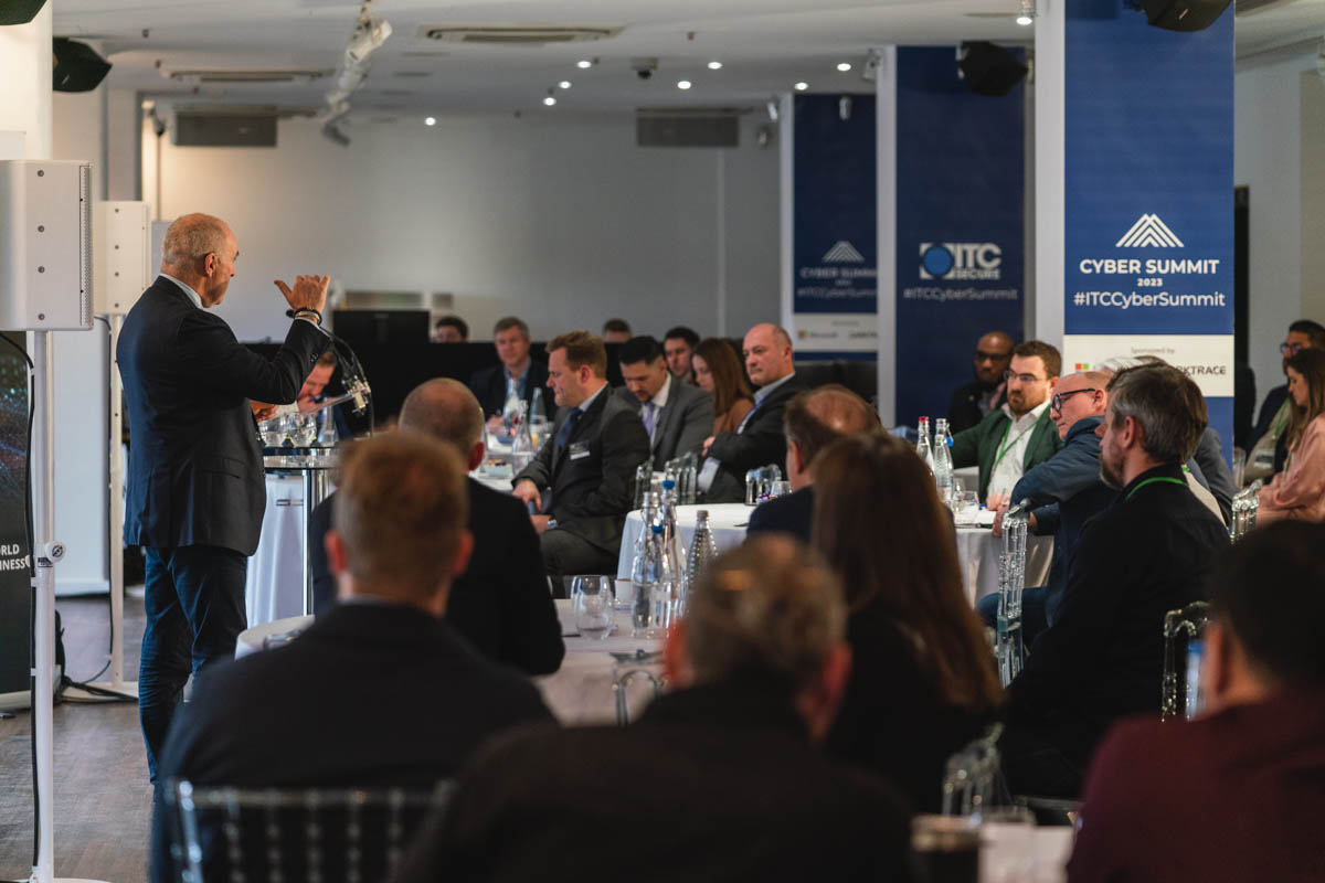 Conference setting at OXO2 with speaker engaging attentive audience, ideal for networking.