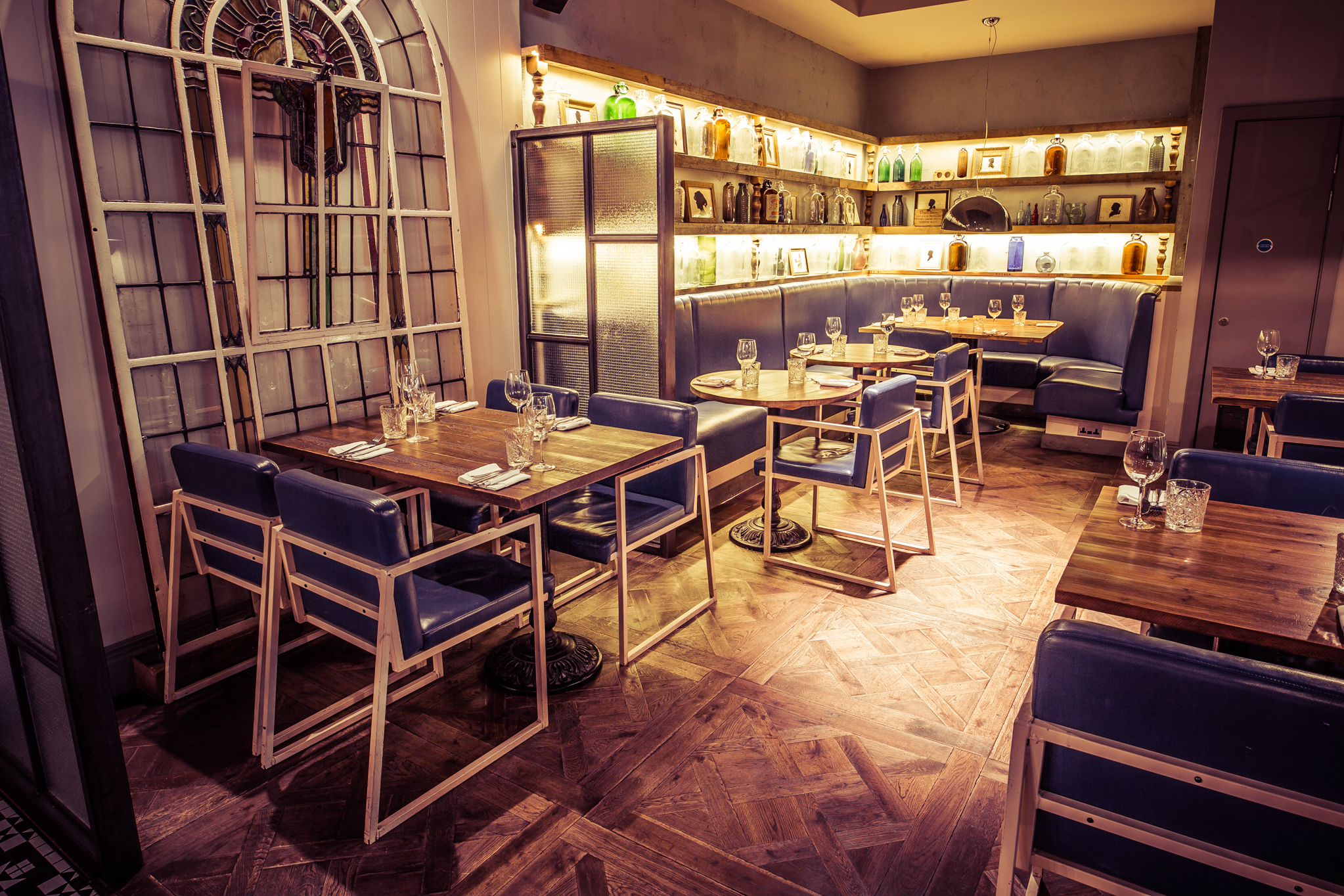 Stylish restaurant venue with wooden tables and sleek seating, ideal for intimate gatherings.
