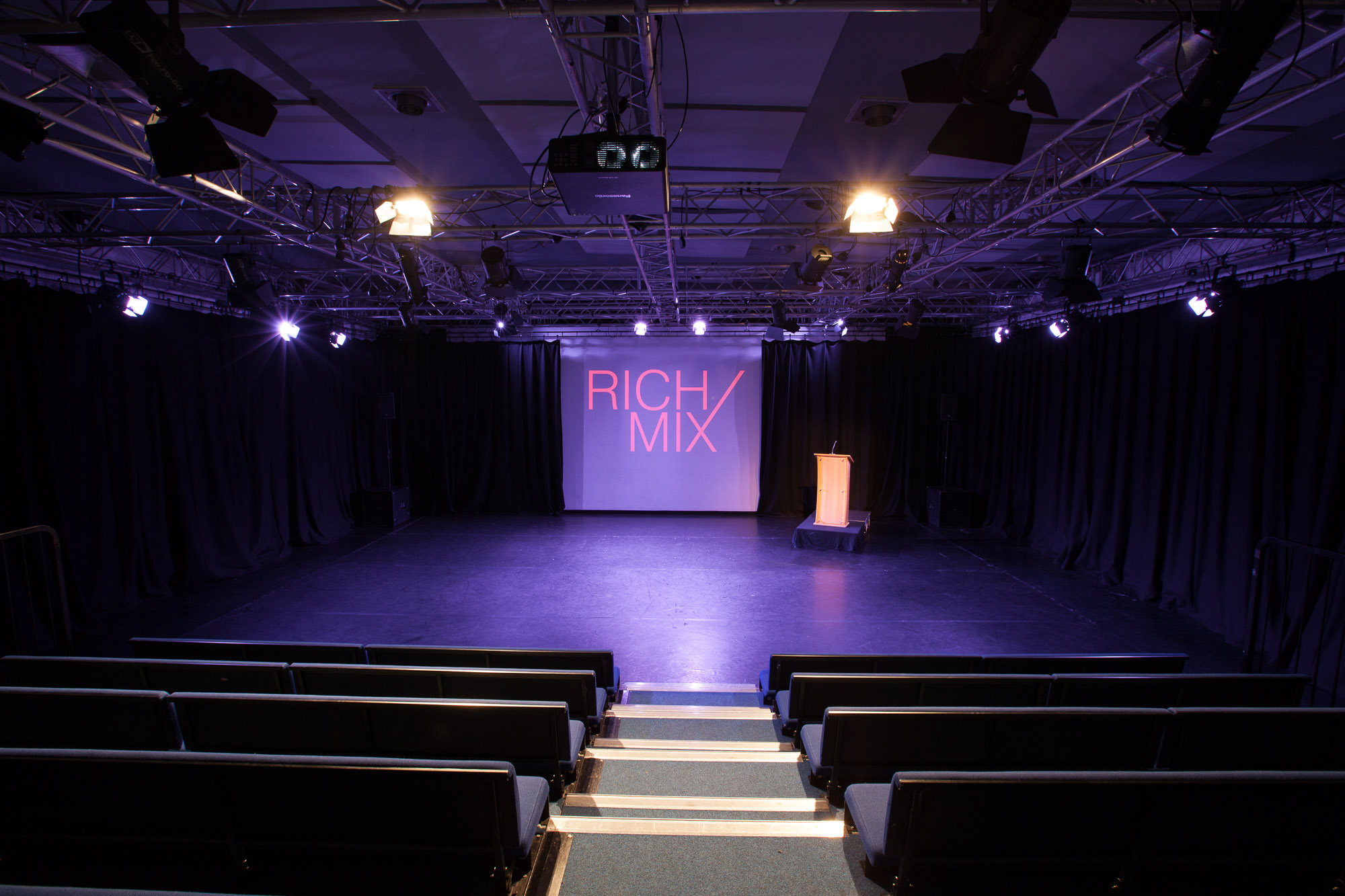 Versatile event space at Rich Mix with stage, ideal for conferences and performances.