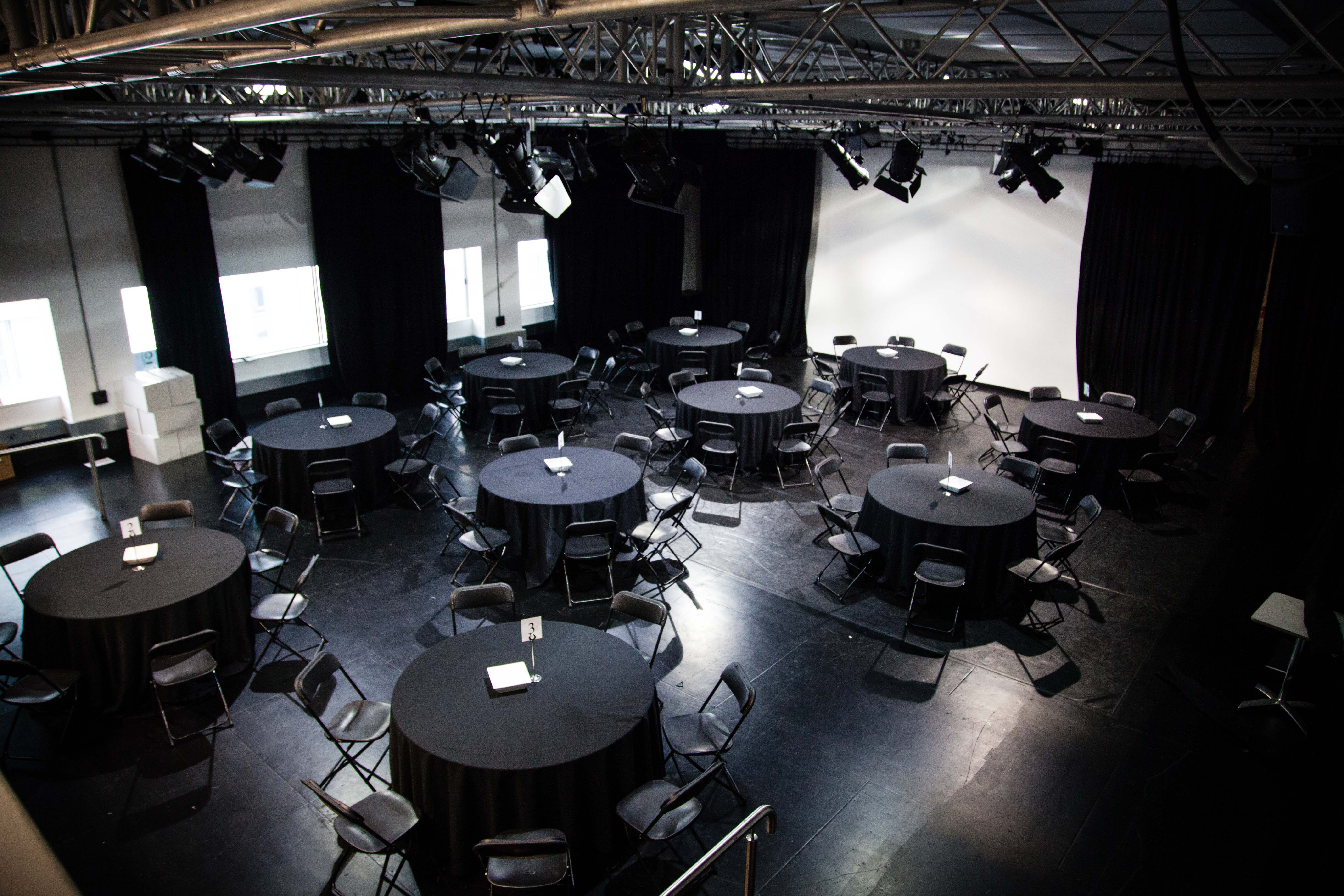 Versatile event space with round tables, ideal for workshops and networking in Rich Mix.