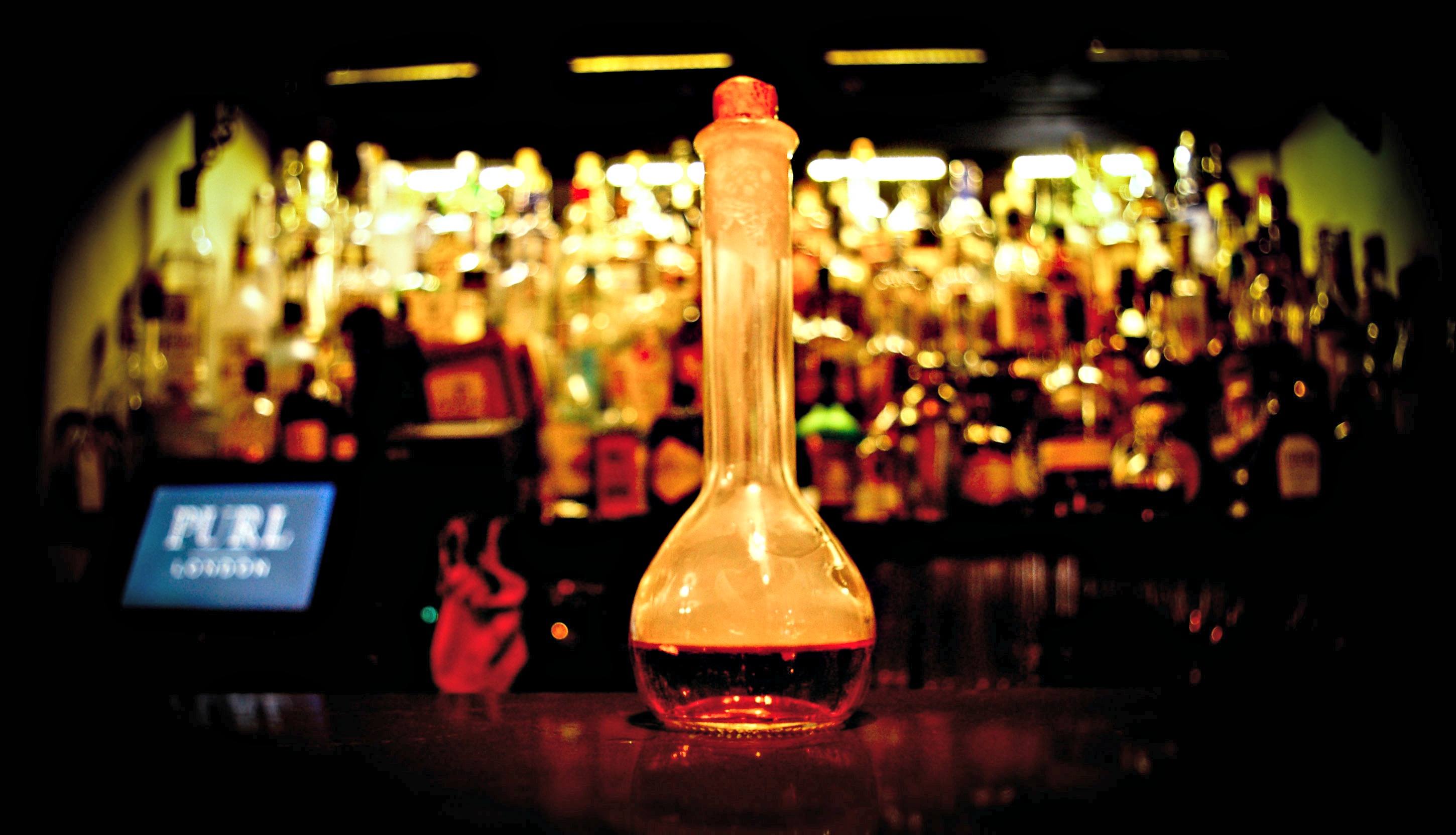 Stylish bar setup with vibrant cocktail at Purl London for events and networking.