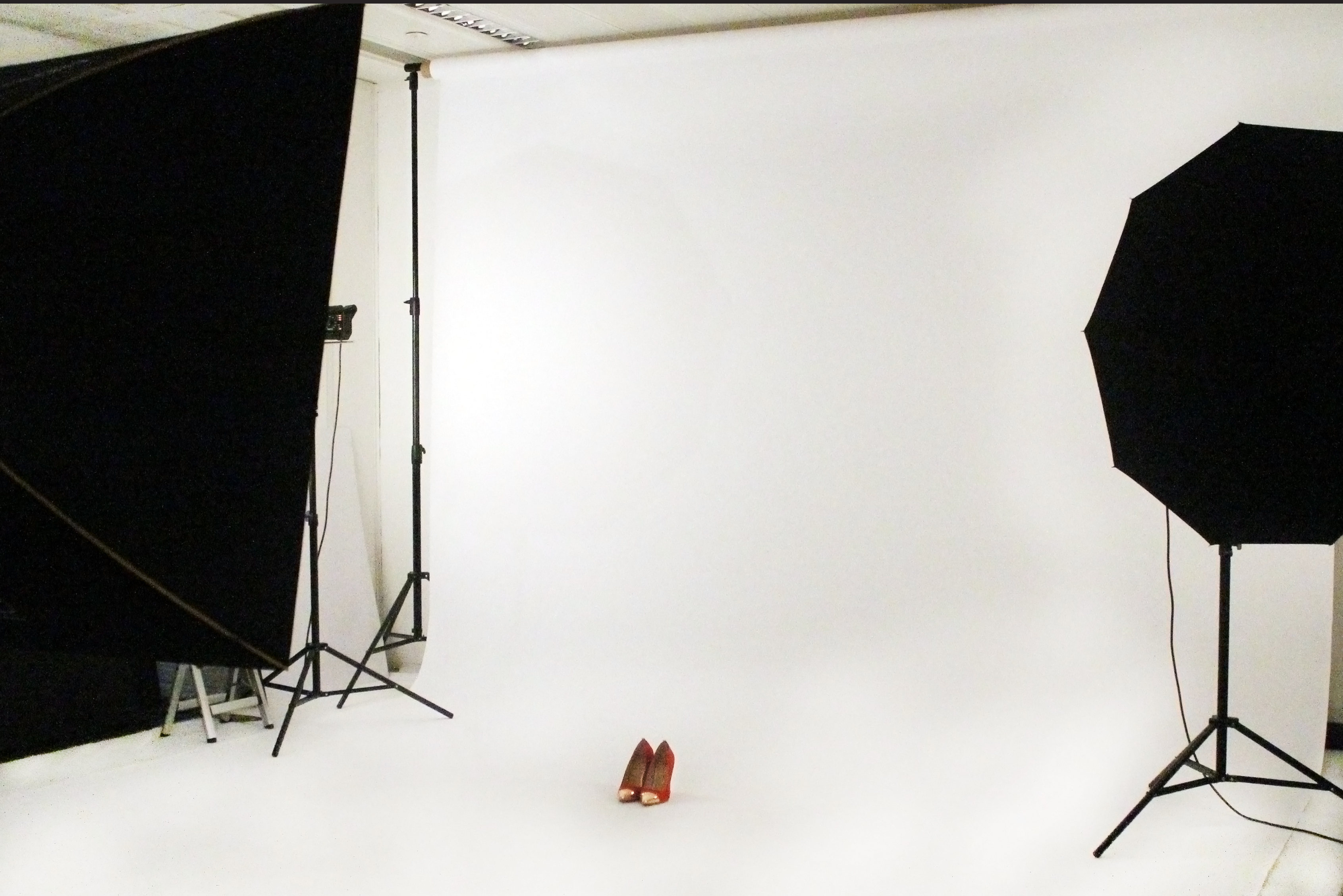 Minimalist studio setup with white backdrop for product photography and promotional events.
