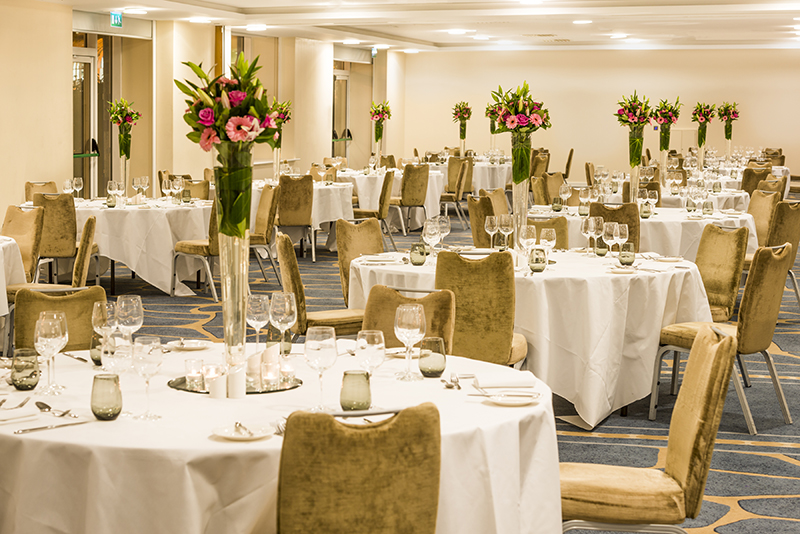 Elegant banquet hall with floral centerpieces, perfect for events and celebrations.