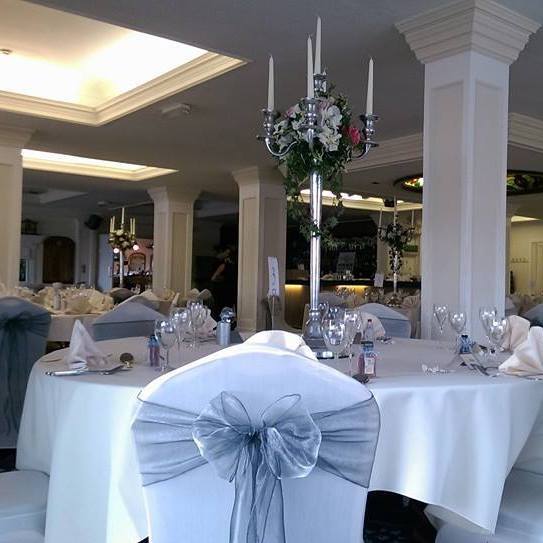 Elegant event space at The Yacht Club with candelabrum centerpiece, ideal for weddings.