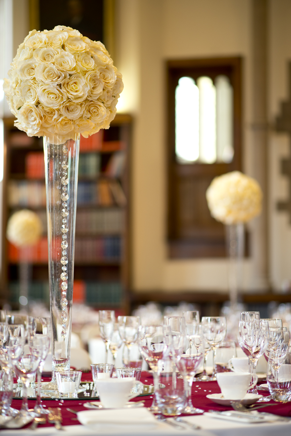 Elegant event setup at Christie's Bistro with tall floral centerpieces for upscale gatherings.