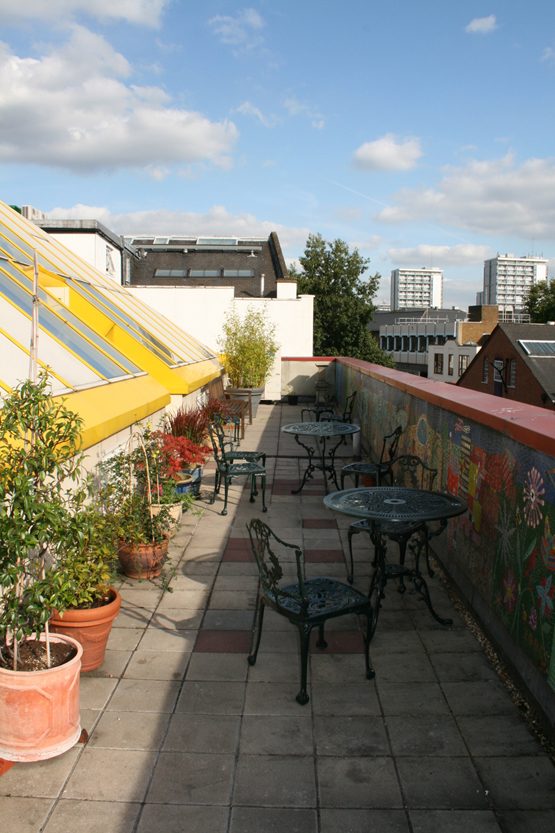 Pyramid Room rooftop terrace with greenery, ideal for casual meetings and networking events.