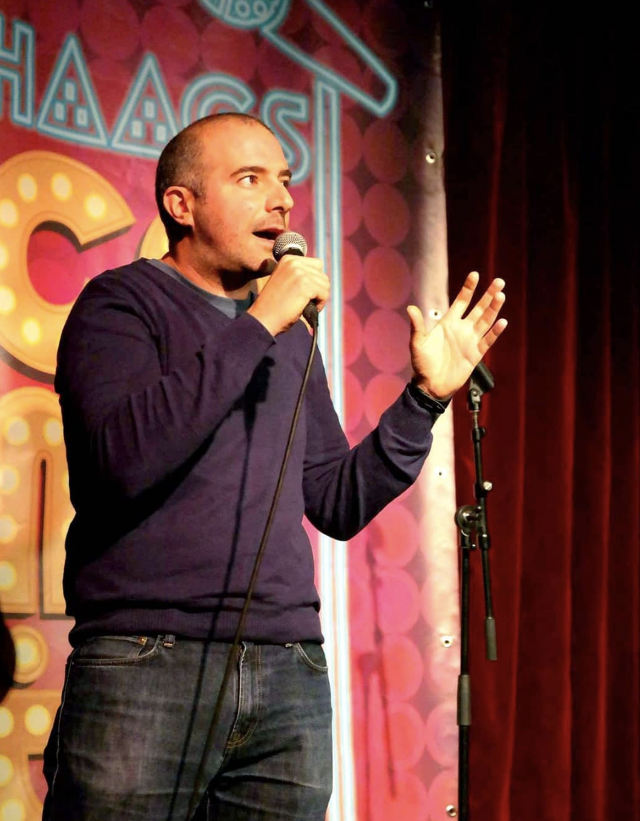 "Dynamic performer with microphone at Bar Rumba, ideal for comedy nights and events."