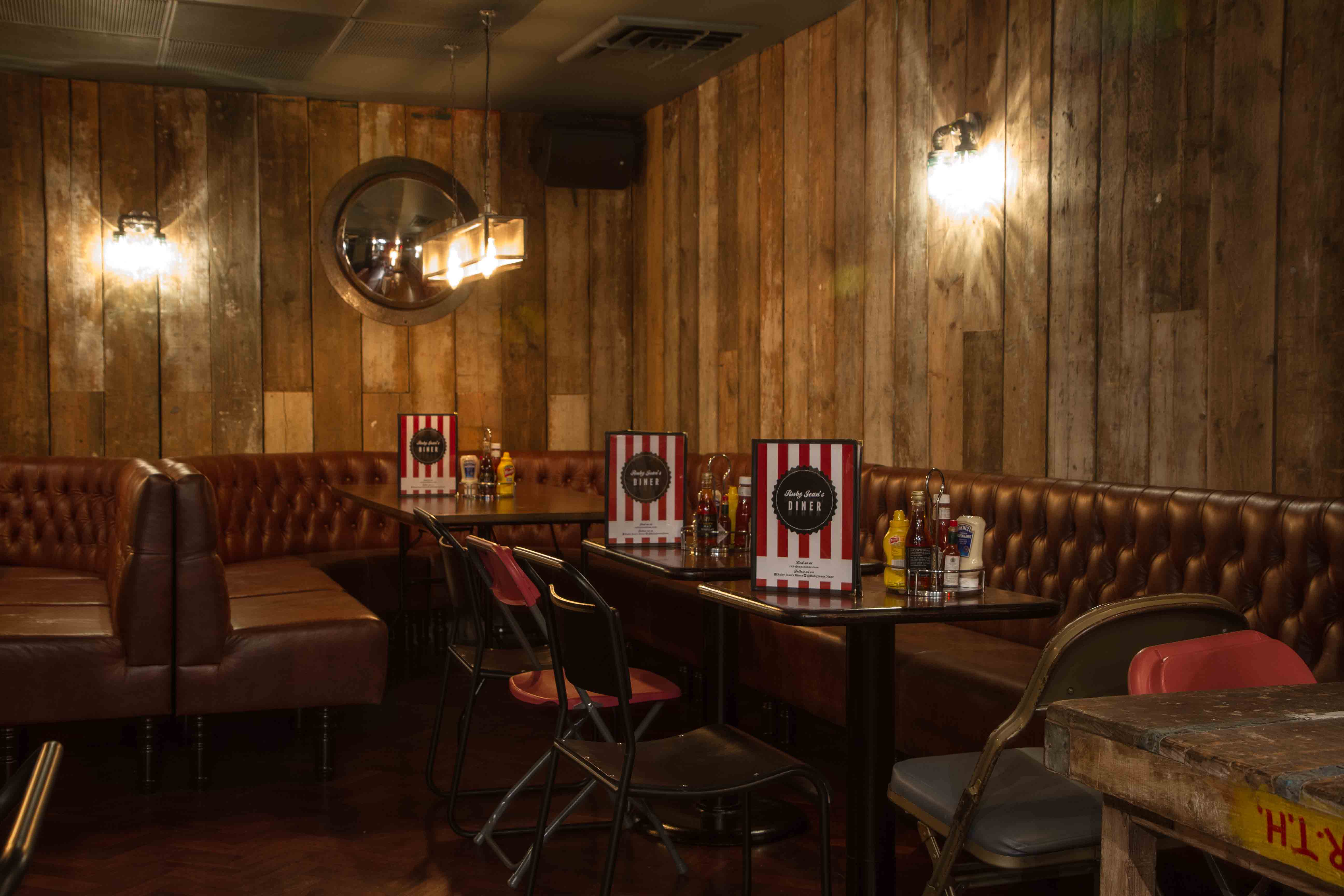 Cozy rustic venue with warm wood paneling for intimate gatherings and casual events.