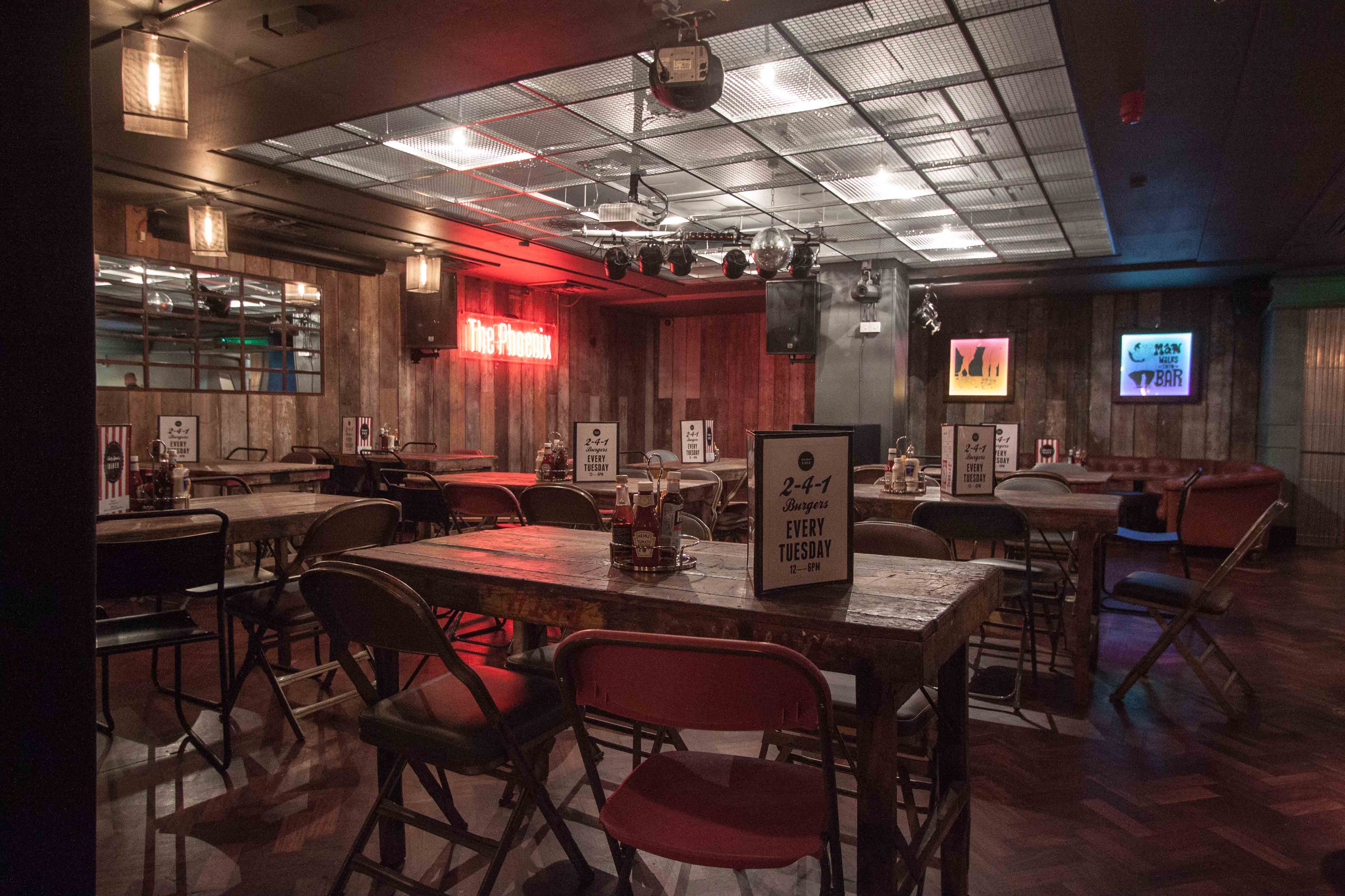 Versatile event space with rustic wooden decor, perfect for casual meetings and social events.