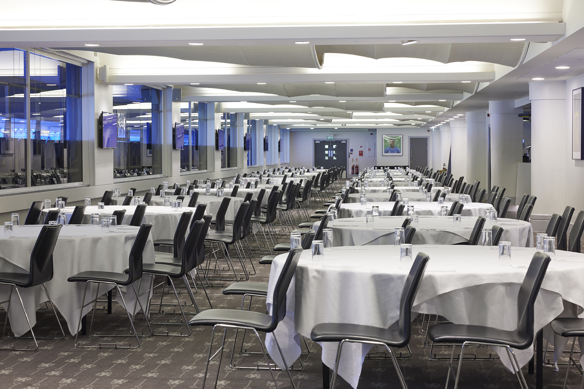Canoville Suite at Chelsea FC, spacious banquet venue with round tables for events.