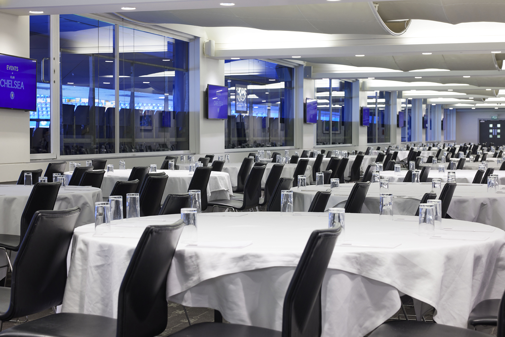 Canoville Suite at Chelsea FC, spacious event venue with round tables for conferences and banquets.