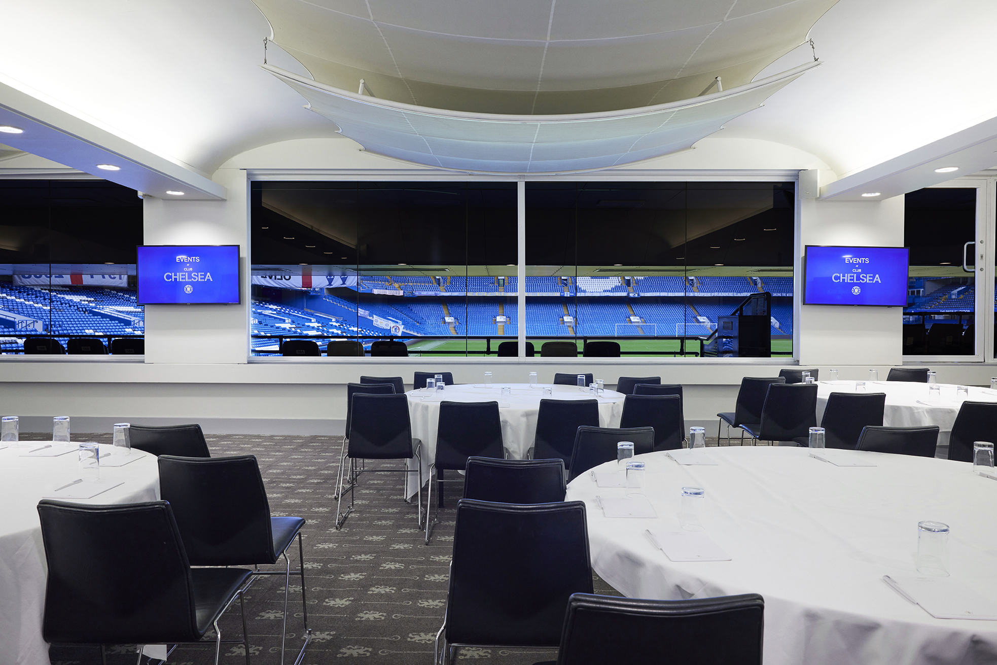 Canoville Suite at Chelsea FC: modern event space with field view for corporate meetings.