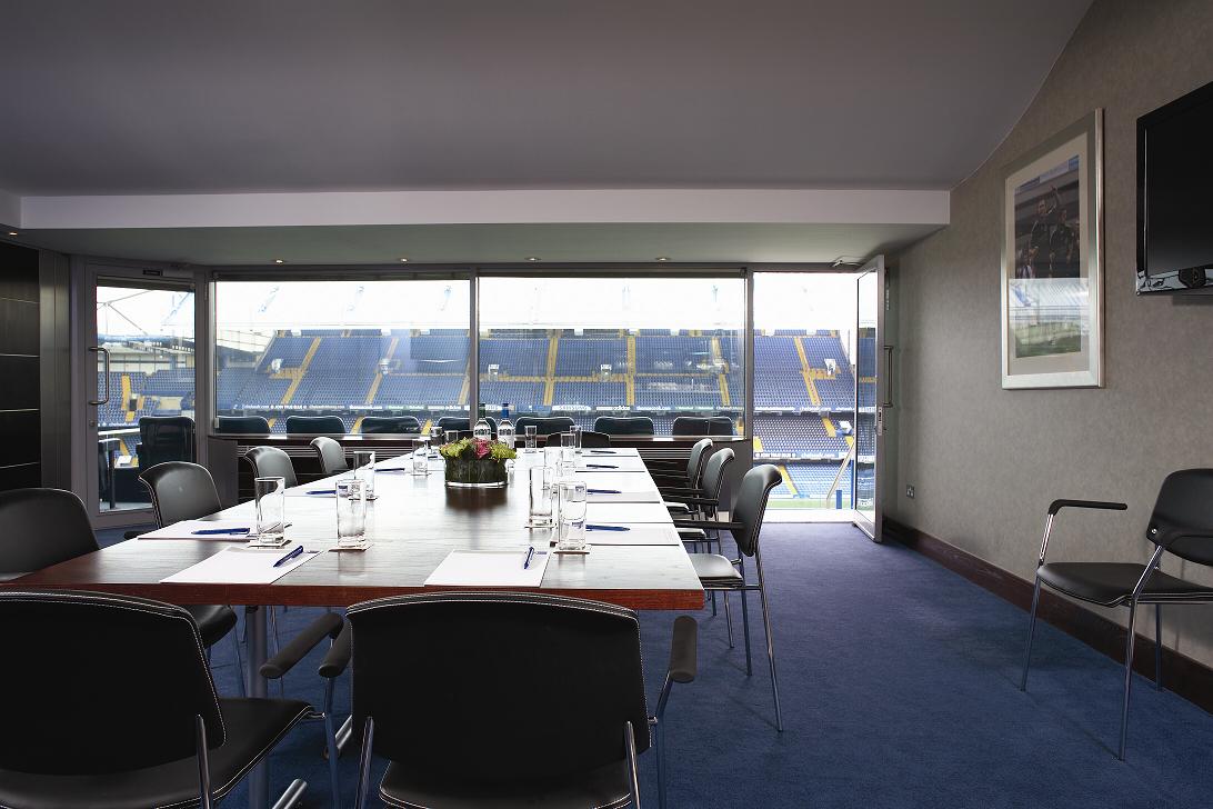 Millennium Suite at Chelsea FC: modern meeting room with stadium view for corporate events.