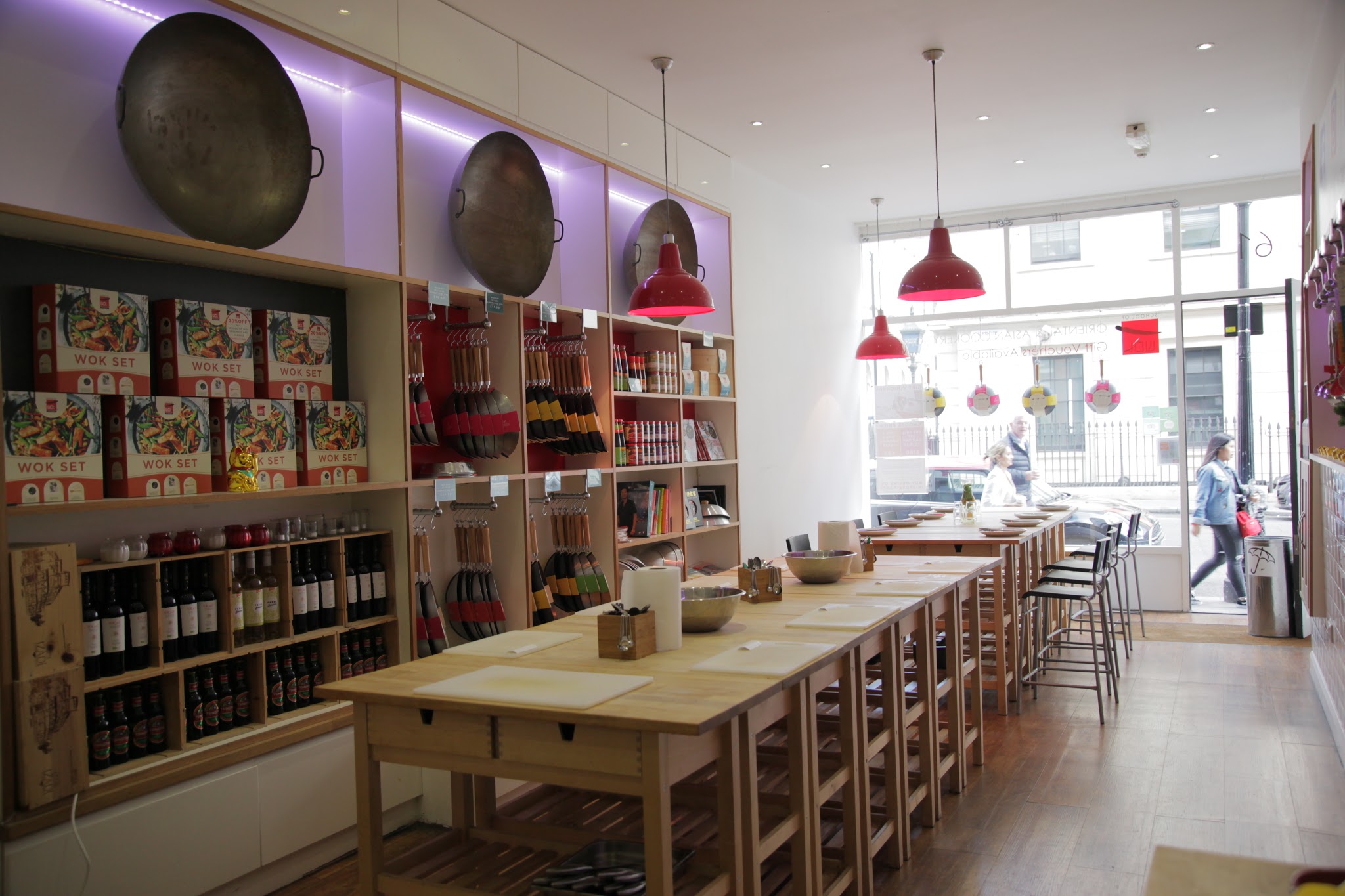 Modern Wok kitchen with communal table for culinary workshops and gatherings.