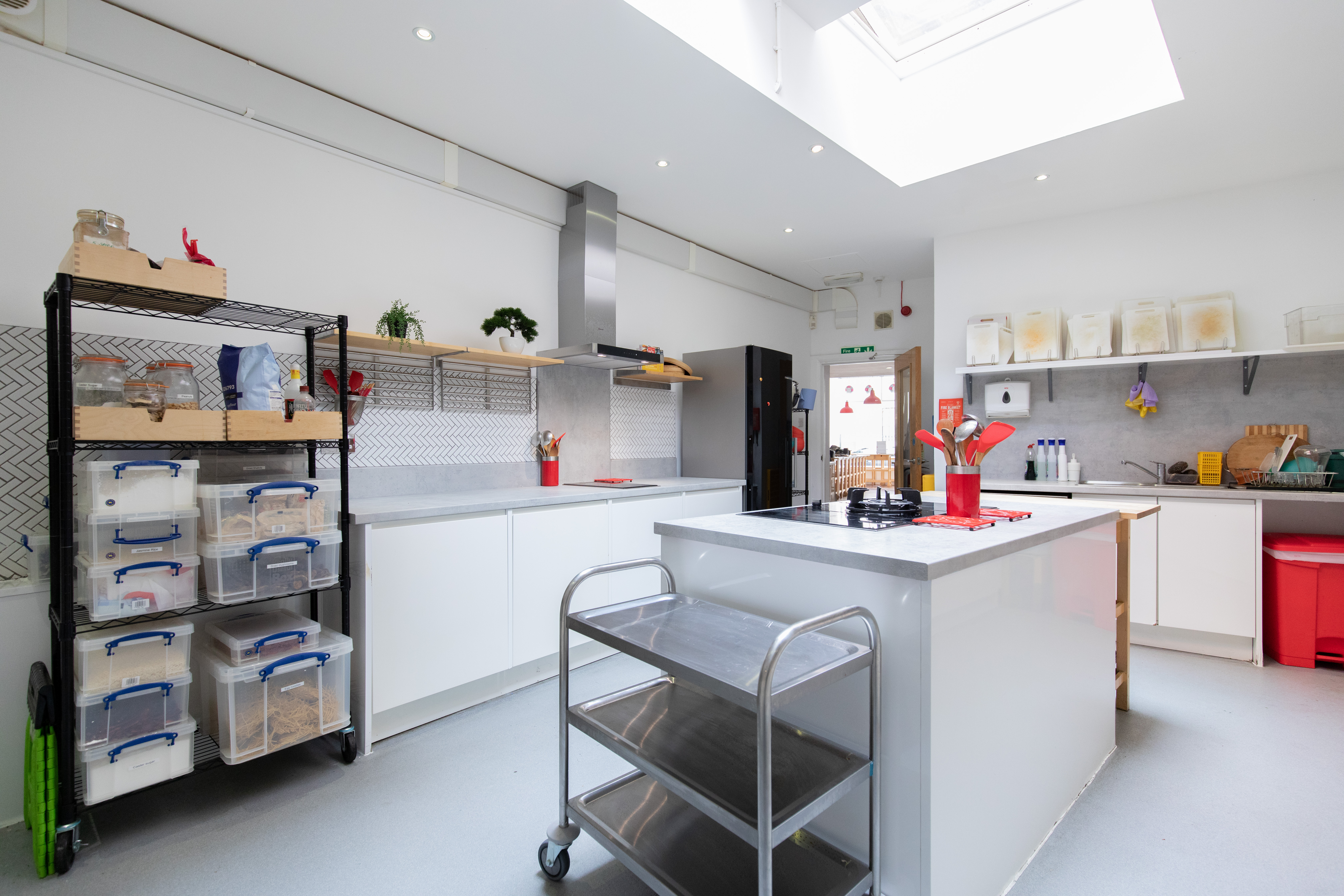 Modern Wok kitchen for culinary workshops with ample counter space and collaboration.