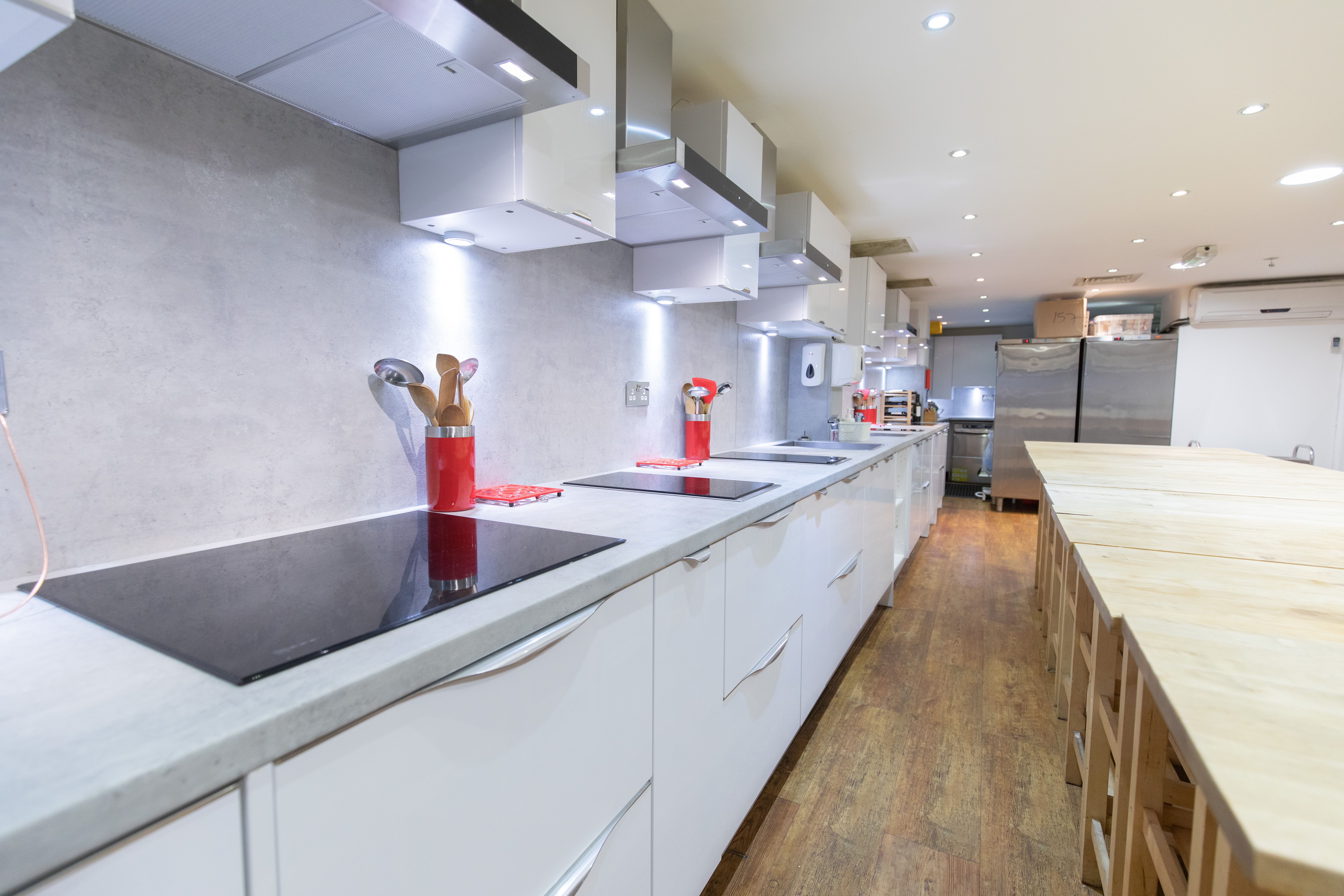 Modern Wok kitchen with sleek countertops for cooking classes and team-building events.