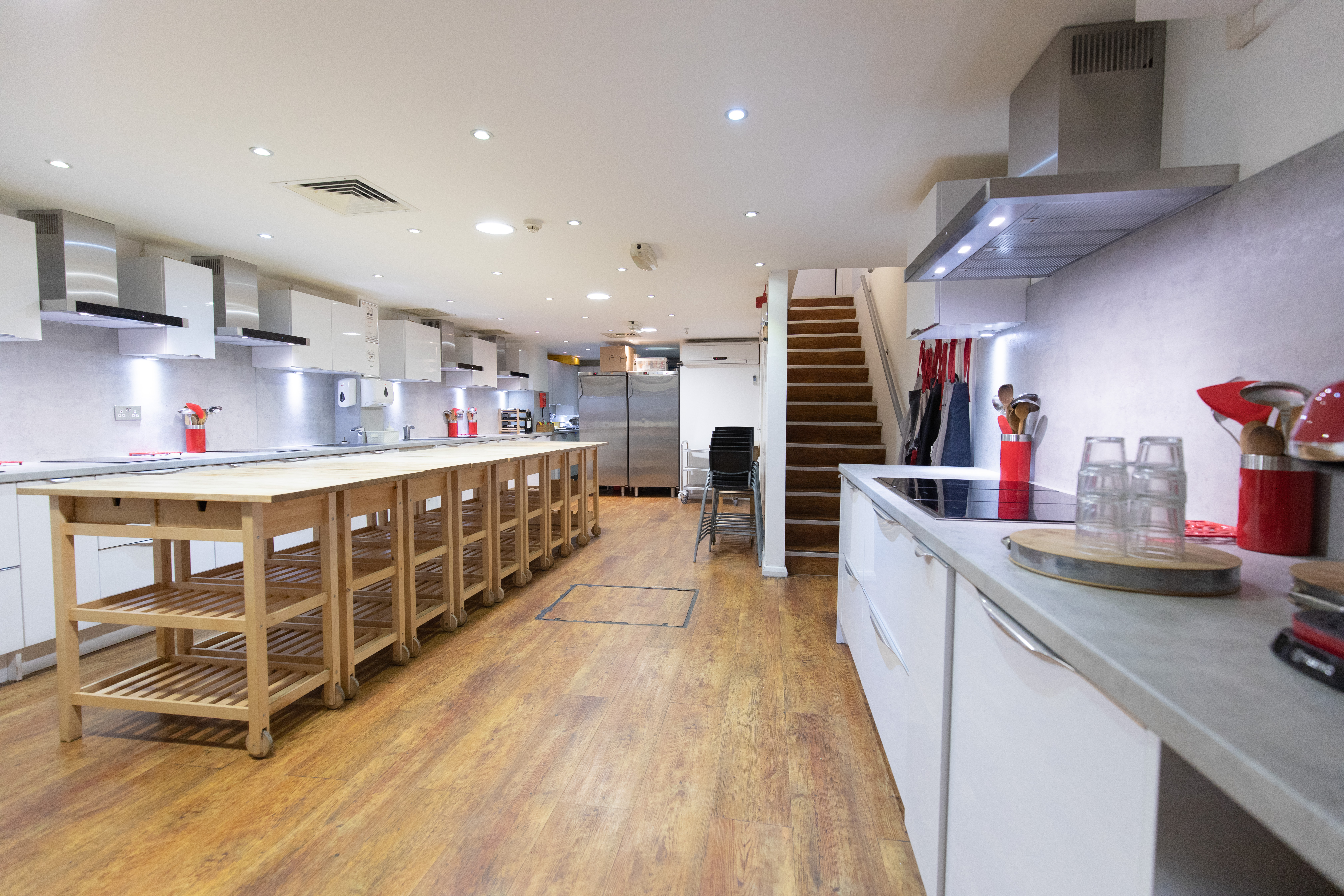 Modern Wok kitchen with professional appliances for culinary workshops and team-building events.