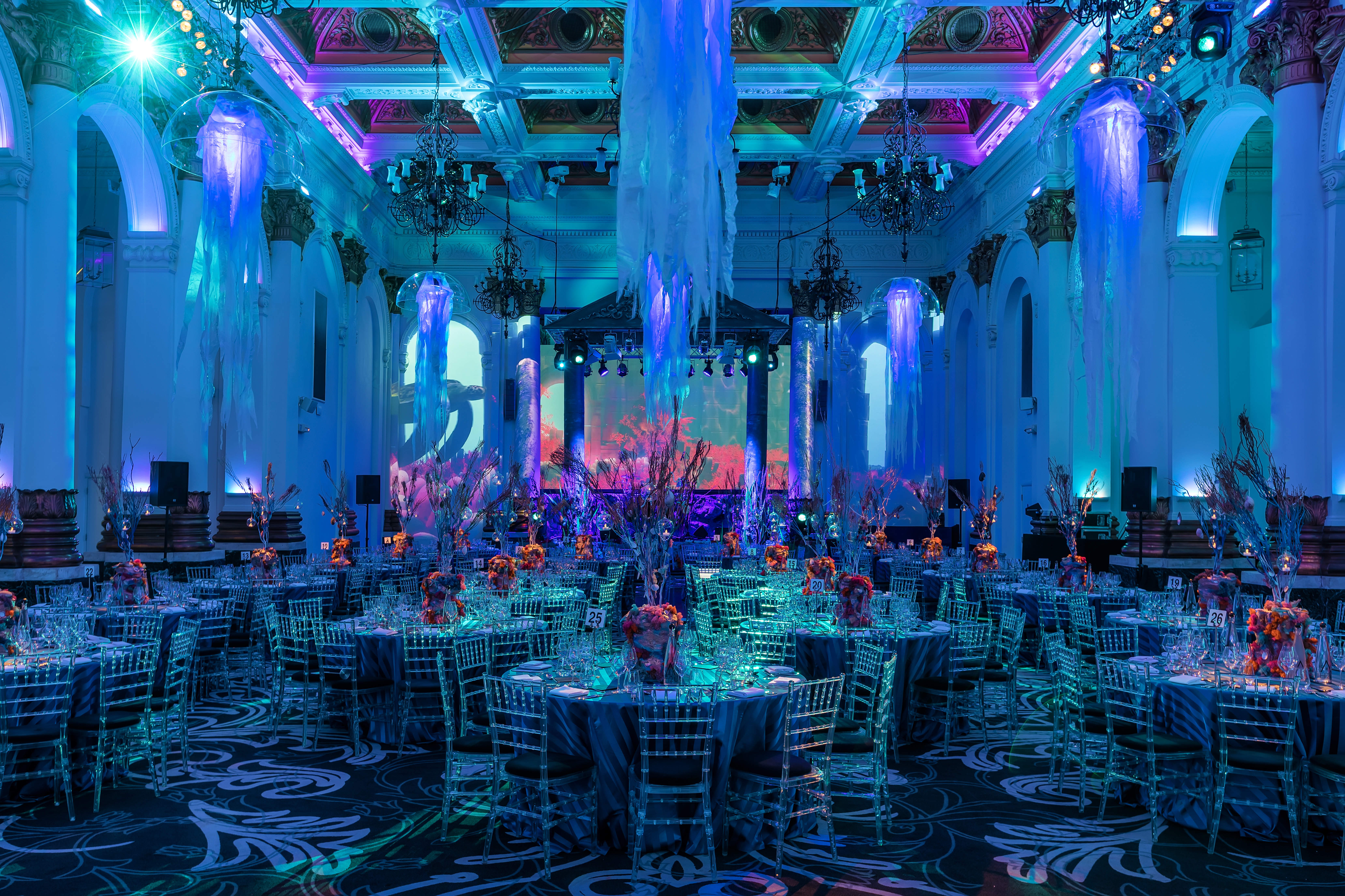 Elegant gala venue with floral centerpieces and ambient lighting at 8 Northumberland Avenue.