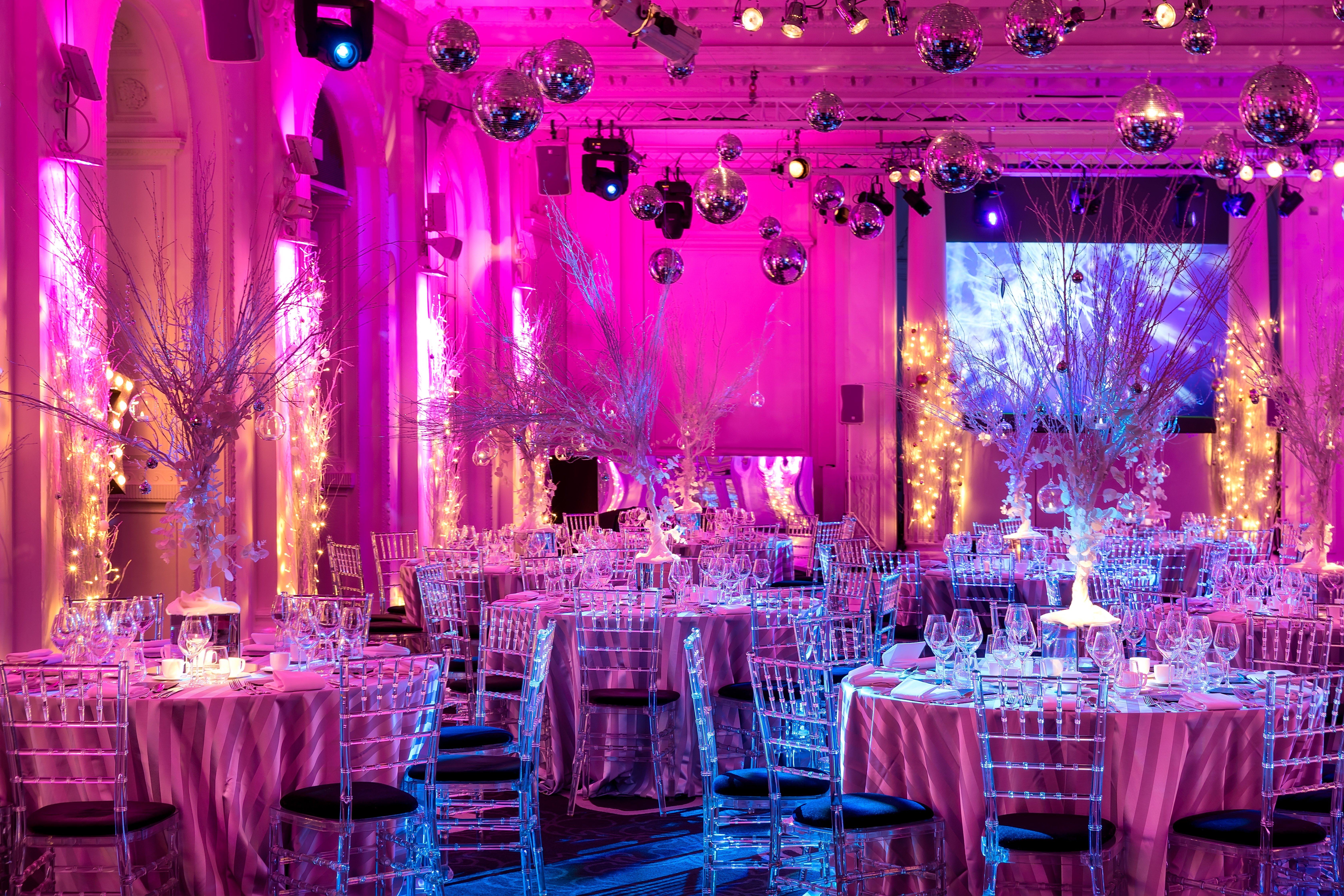 Elegant event space with pink linens, ideal for weddings and gala dinners.