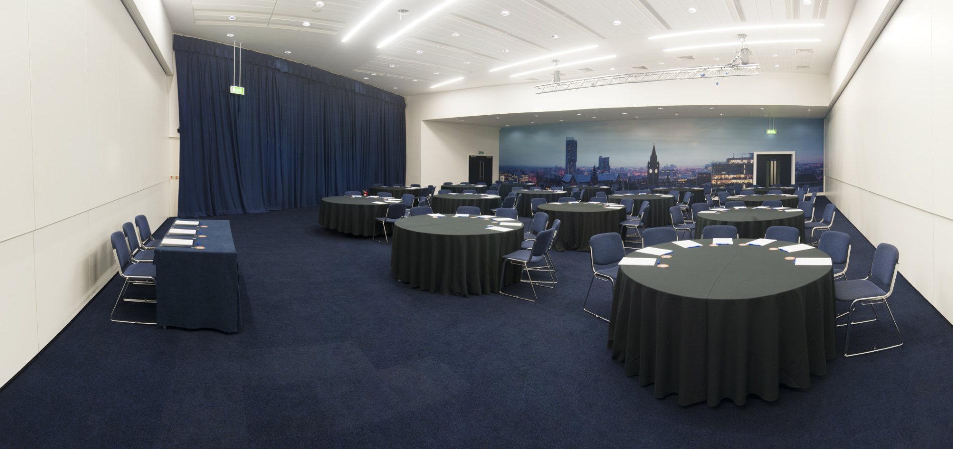 Event space in Manchester Central with round tables for conferences and workshops.