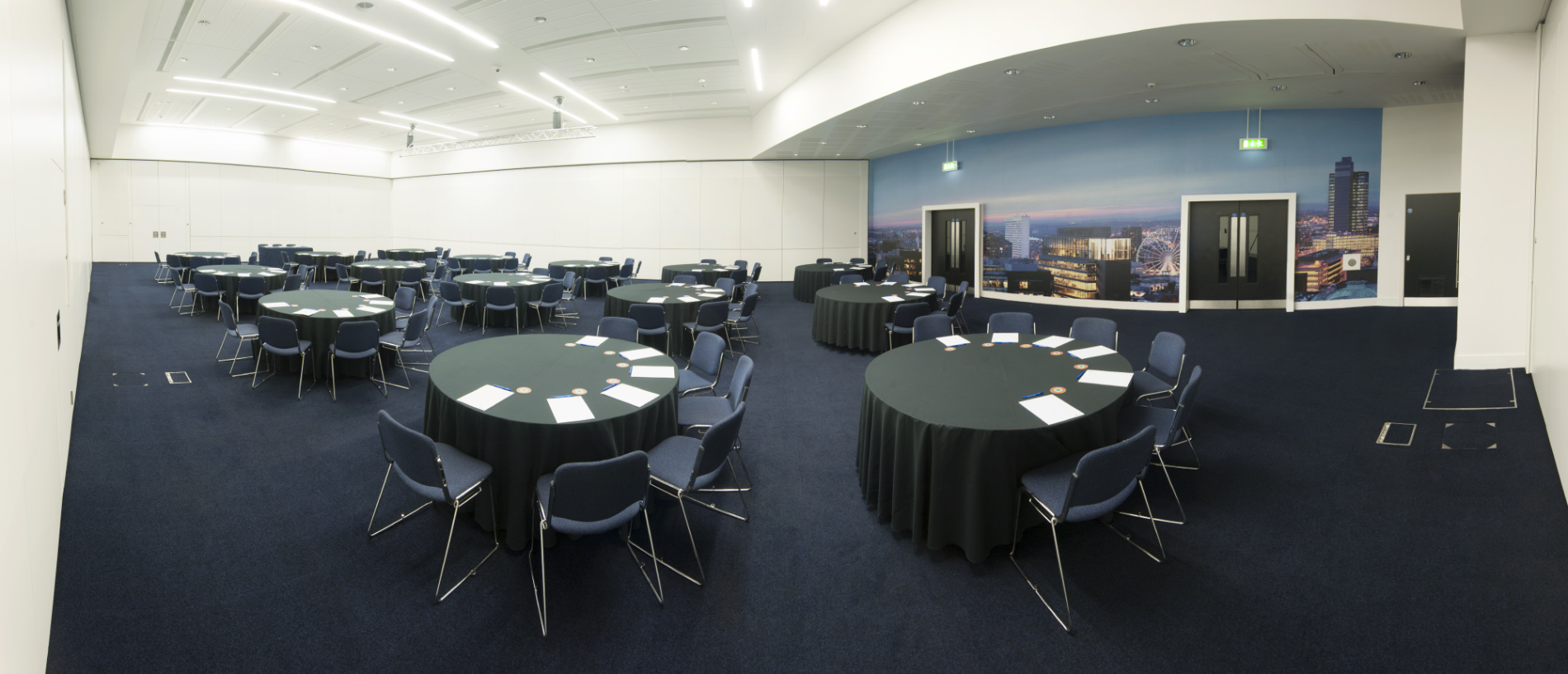 Spacious Charter 3 venue in Manchester Central set for meetings with round tables.