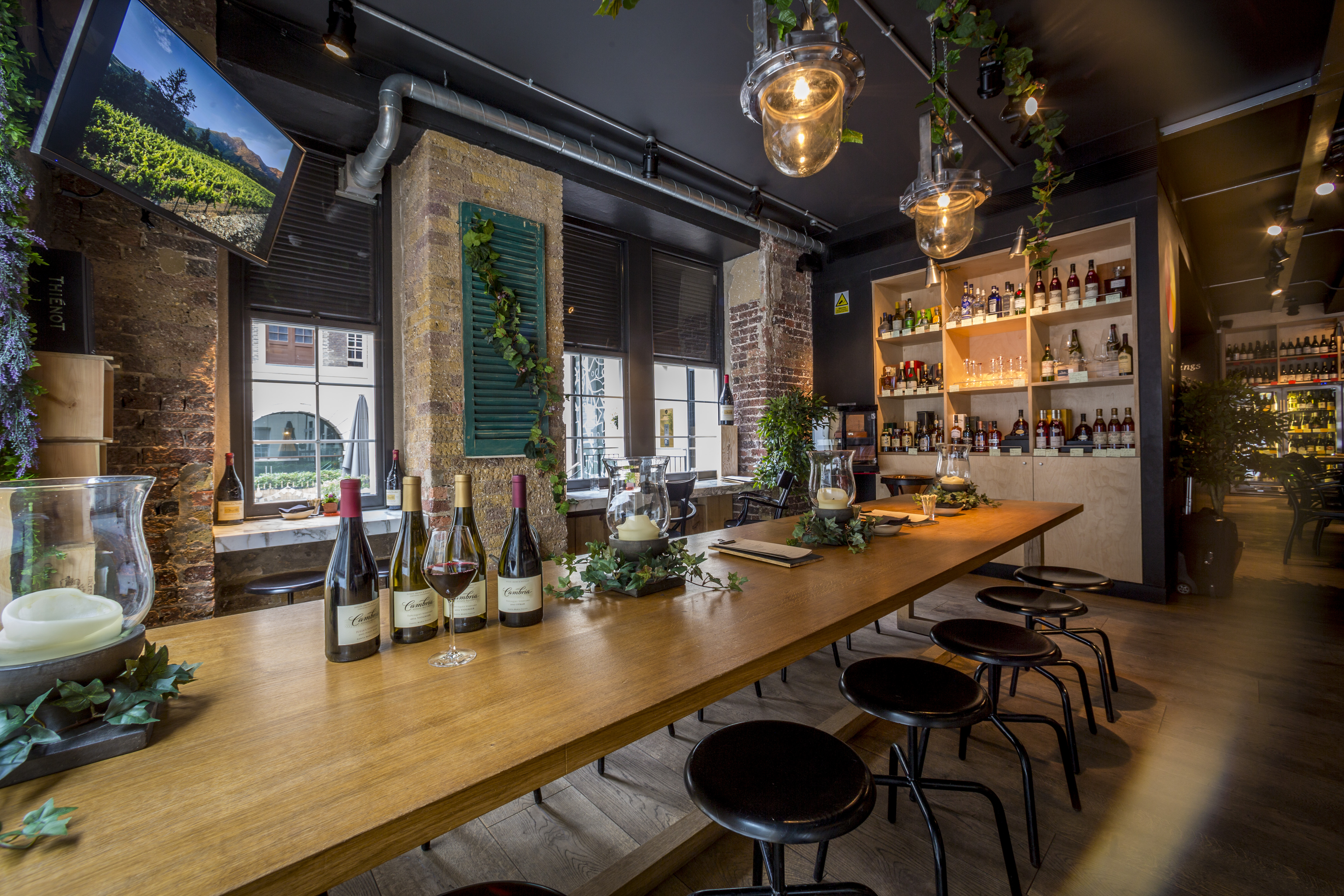 Stylish venue with wooden table, ideal for wine tastings and corporate events.