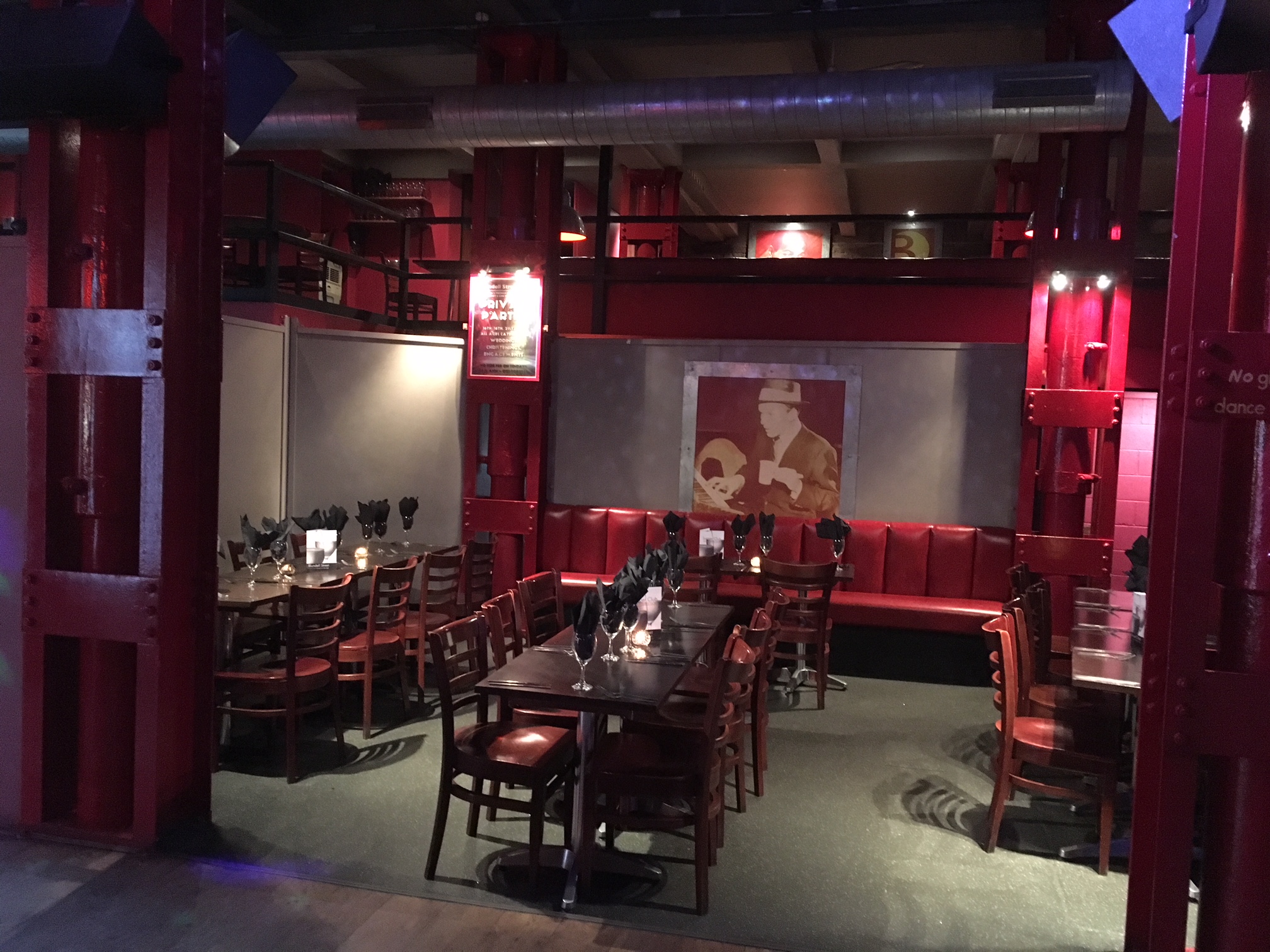 Intimate function room with red accents for corporate meetings and private events.