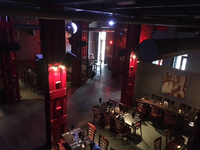 Spacious Blundell Street event venue with red pillars for corporate meetings and social gatherings.