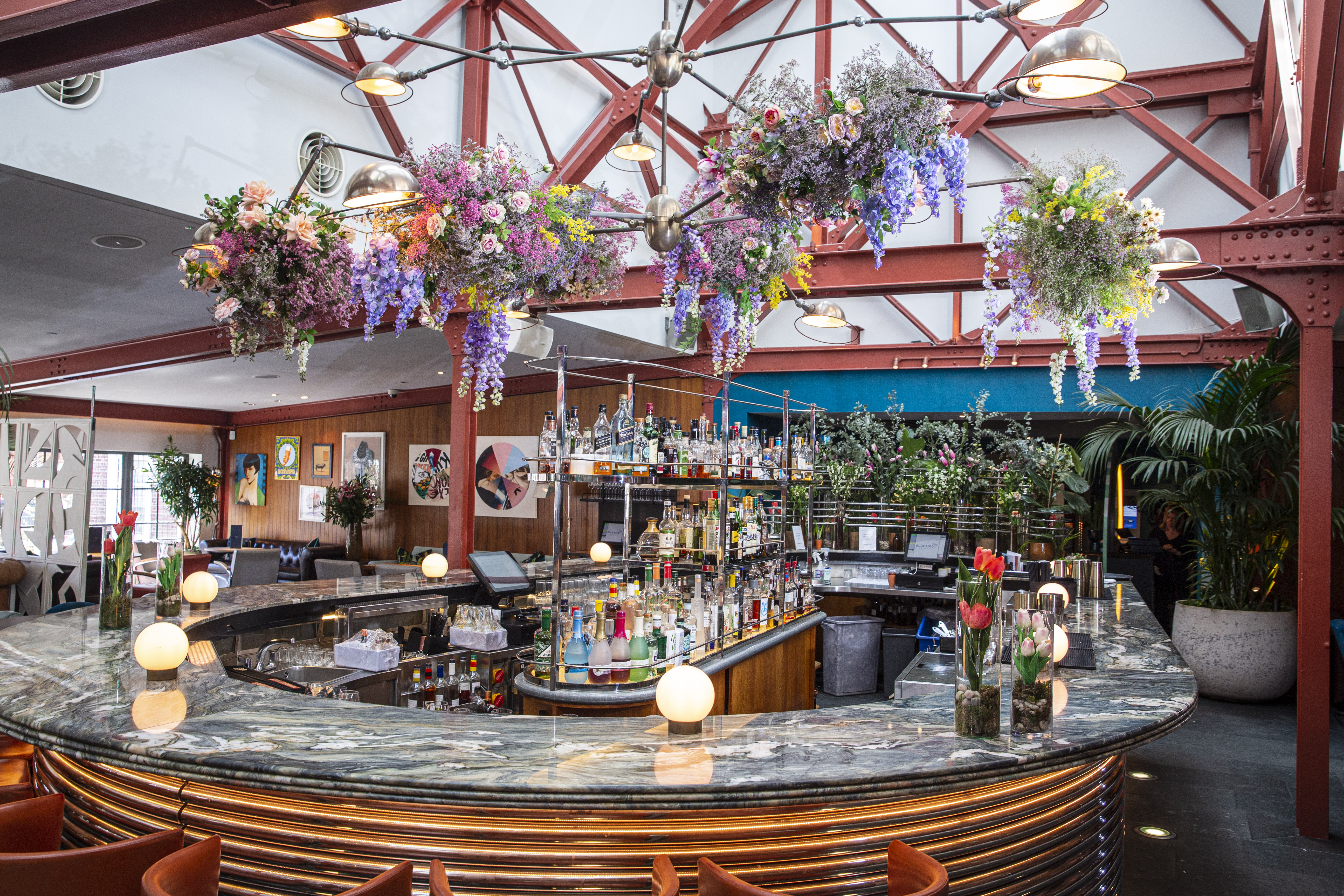 Main Restaurant at Bluebird Chelsea with floral installation, ideal for events and gatherings.