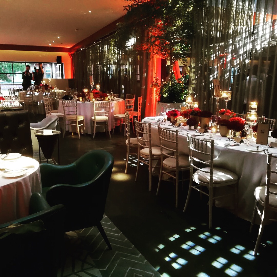 Elegant event space at Bluebird Chelsea with floral centerpieces for gatherings.