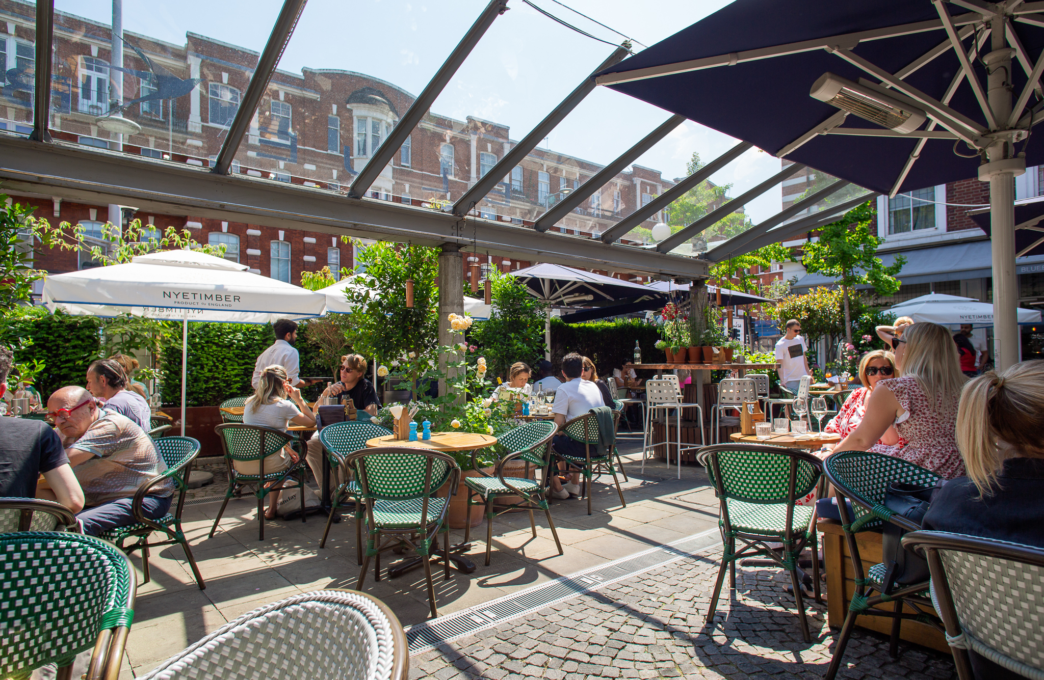 Vibrant outdoor café in Bluebird Chelsea, ideal for casual meetings and networking events.