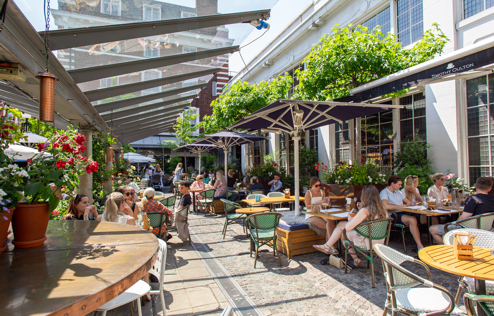 Vibrant outdoor dining space at Bluebird Chelsea, perfect for networking events and gatherings.