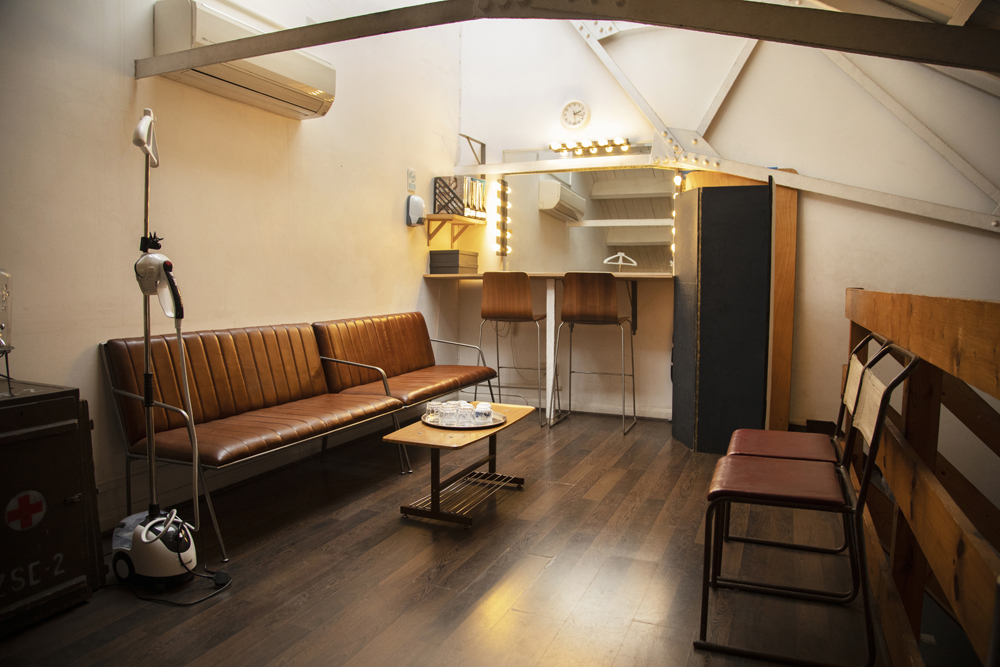 Stylish event preparation area with modern vanity and warm lighting in Espero Studio.