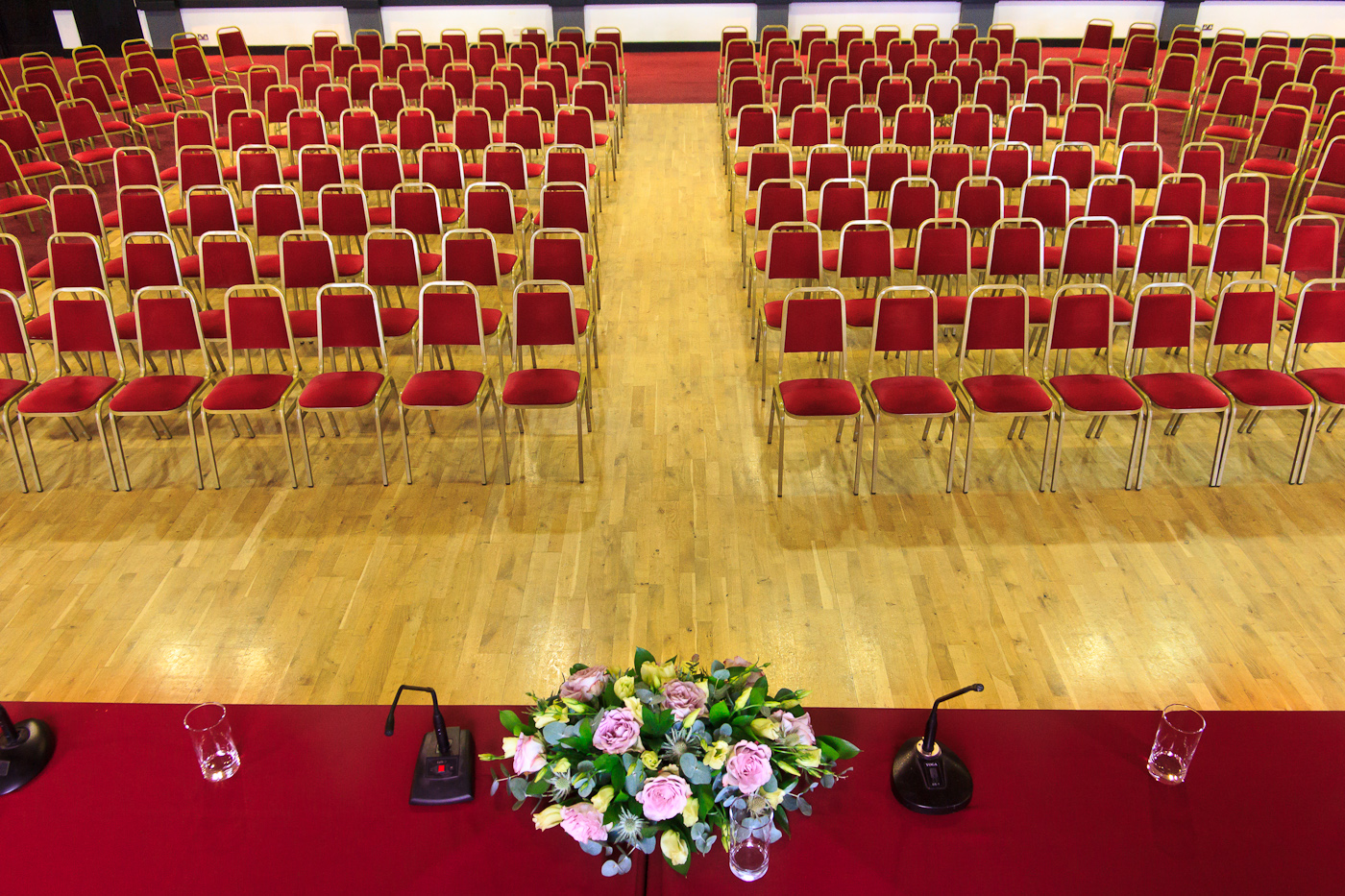 McNamara Suite event space with red chairs, ready for a presentation or panel discussion.