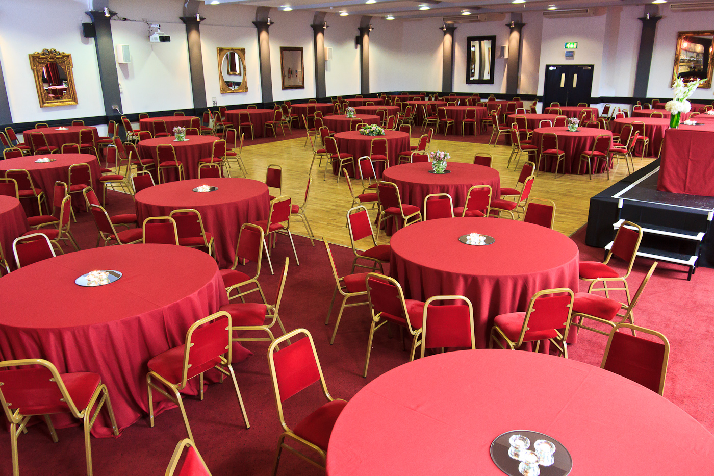 McNamara Suite at The London Irish Centre, elegant banquet venue with red tablecloths.