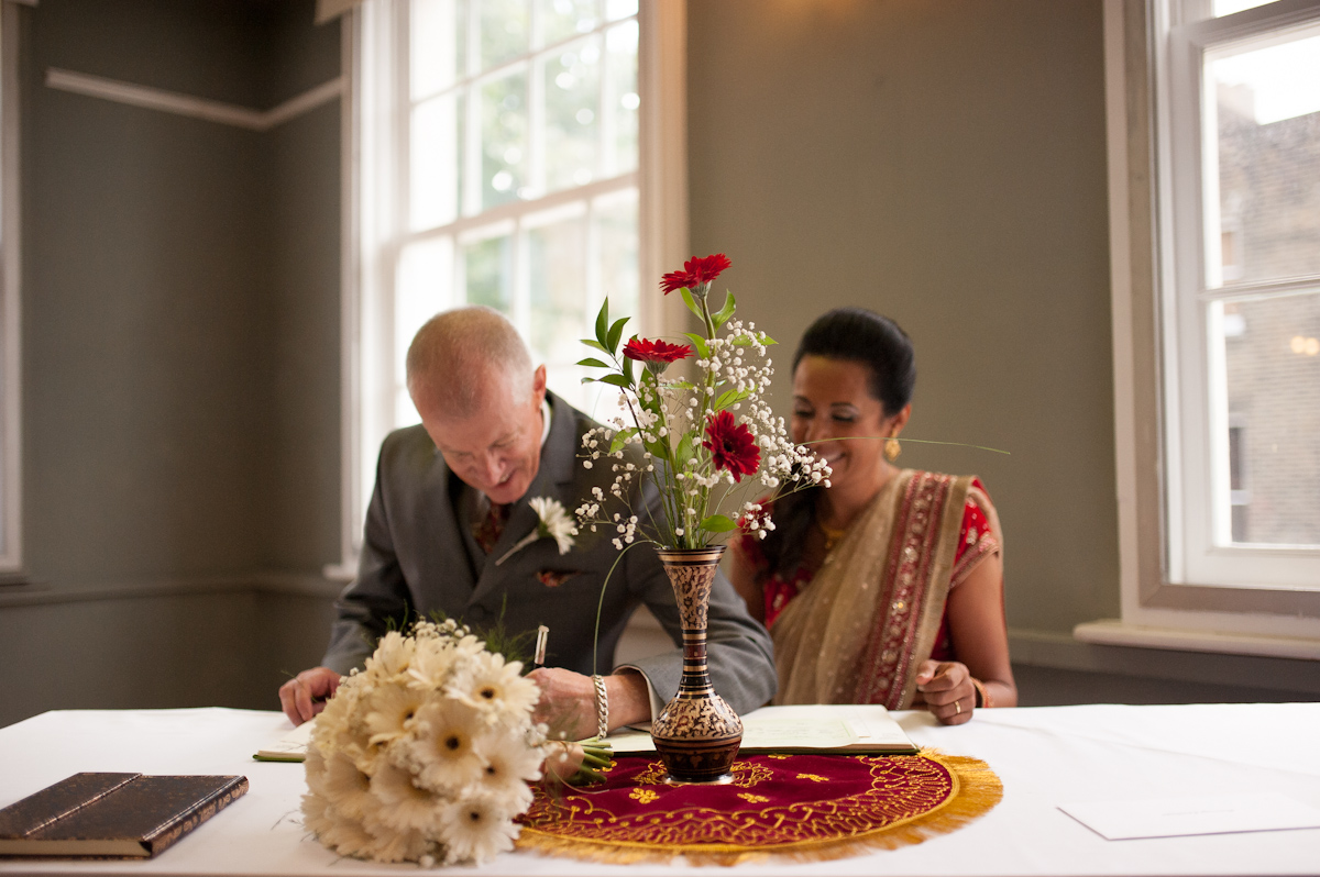 Couple in traditional attire at McNamara Suite, London Irish Centre wedding event.
