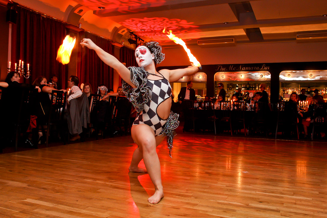 Fire dancer in striking costume performing at The London Irish Centre event.