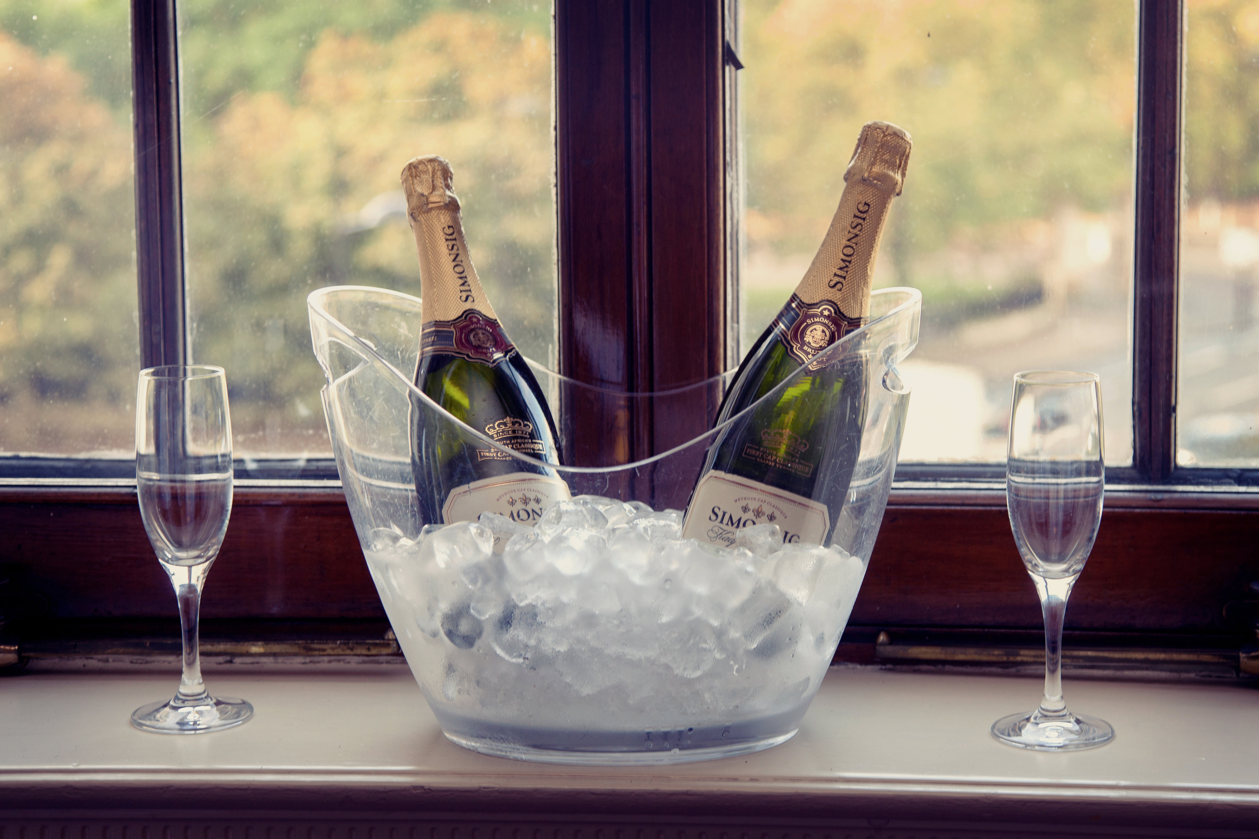 Stylish ice bucket with champagne and flutes, perfect for weddings or corporate events.