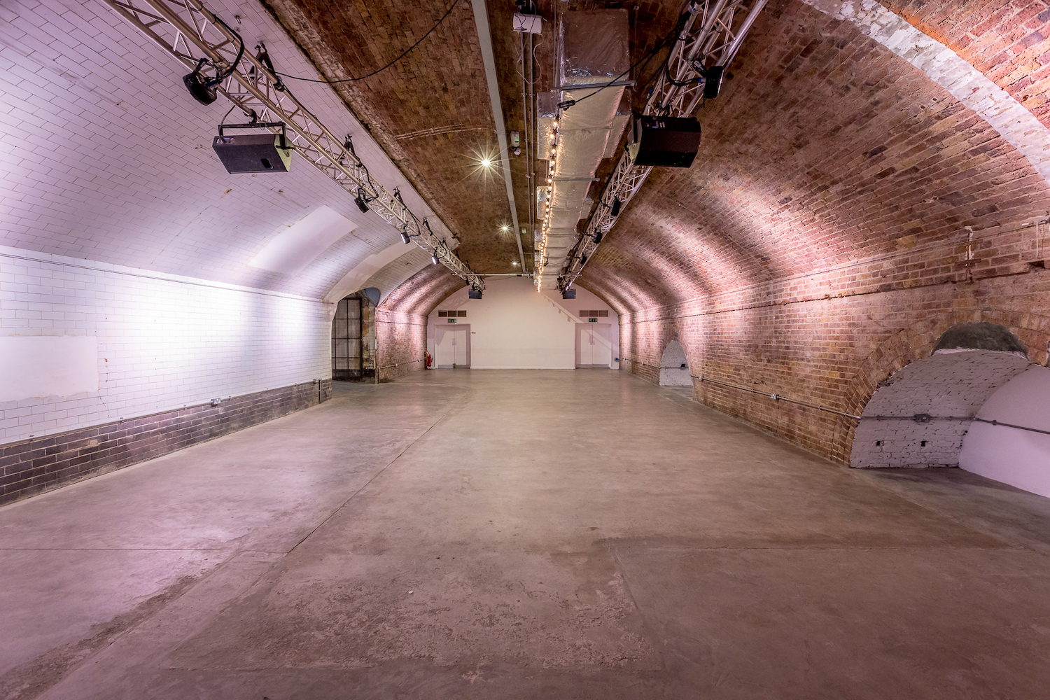 Versatile event space in Kachette Shoreditch with exposed brick arches for corporate events.