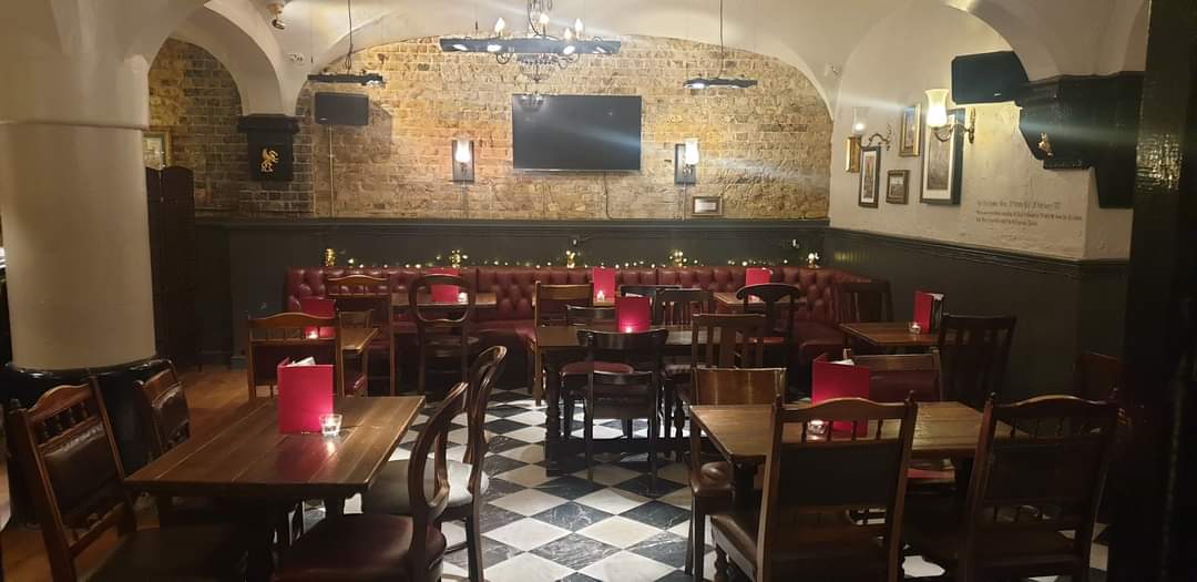 Cozy Marthas Cellar Bar with wooden seating, perfect for intimate gatherings and events.