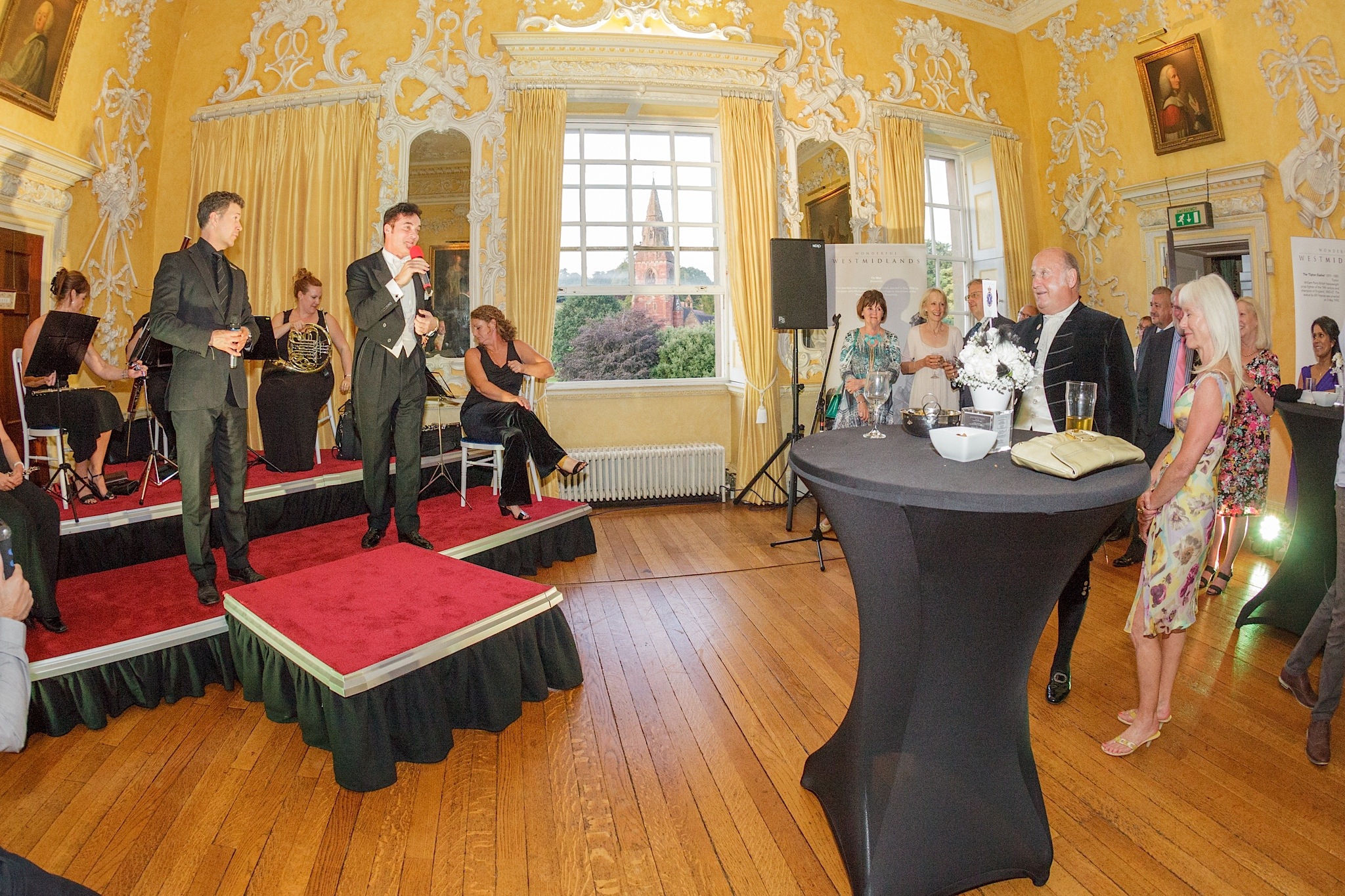 Lively event in The Saloon, Hagley Hall with vibrant decor and networking atmosphere.