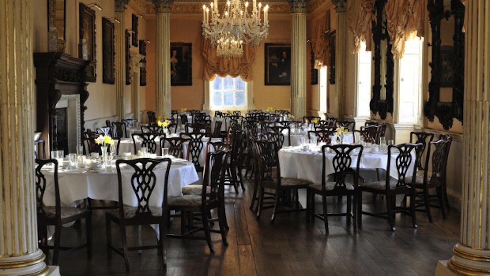 Elegant dining room in Long Gallery, Hagley Hall, set for upscale events with floral centerpieces.