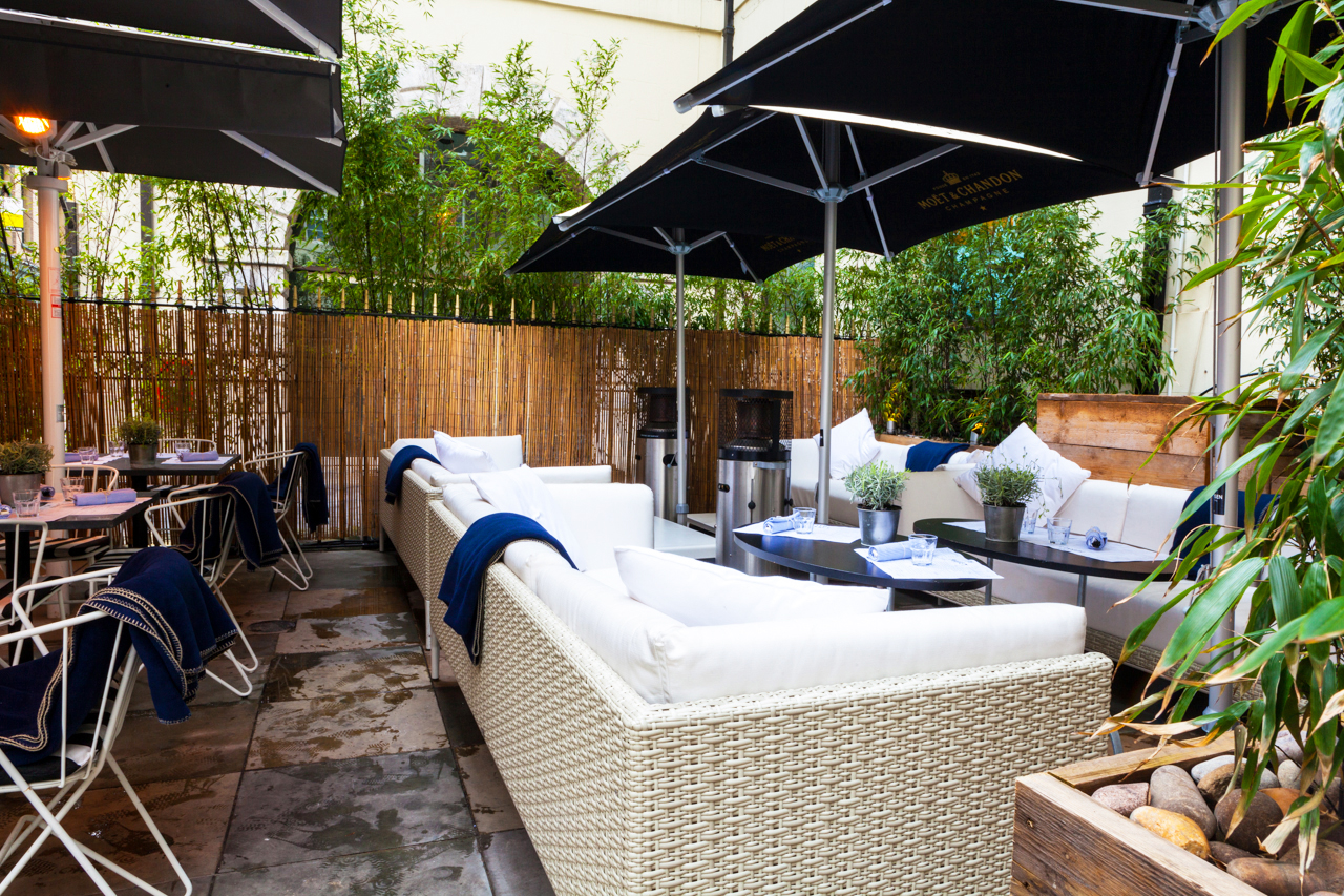 Stylish outdoor lounge at Fish Market, perfect for networking events with comfortable seating.