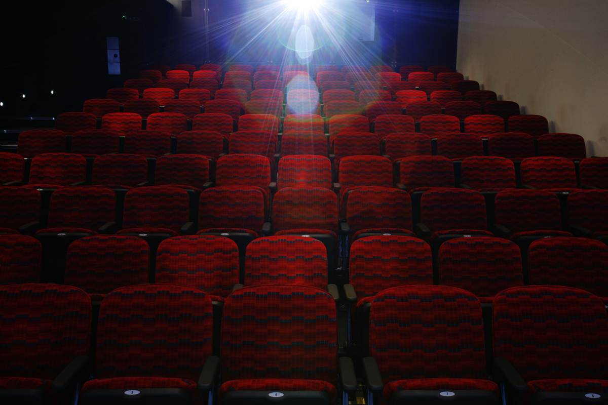 Cubic Theatre seating with red chairs, ideal for presentations and film screenings.