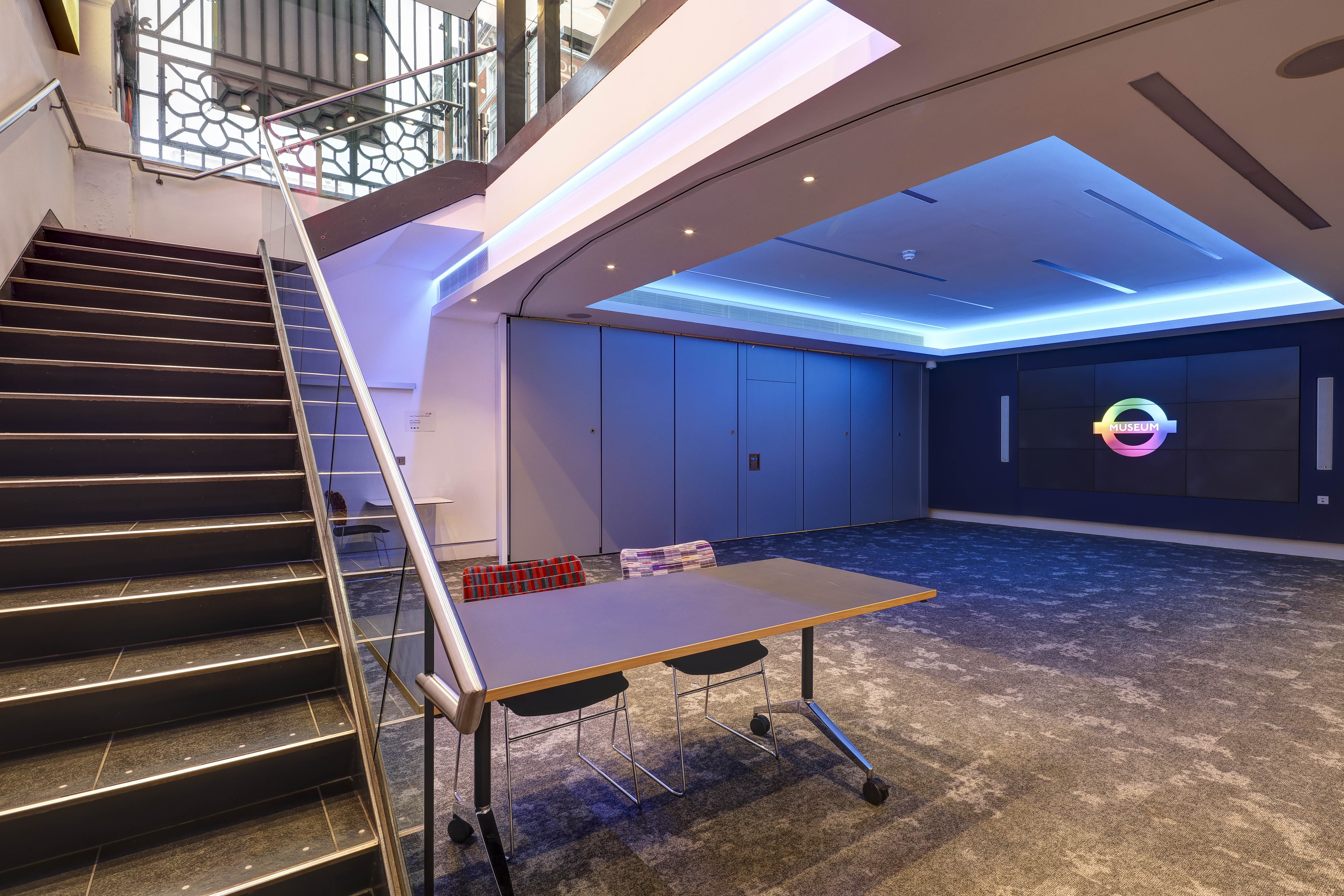 Cubic Theatre at London Transport Museum: modern event space with sleek staircase, ideal for meetings.