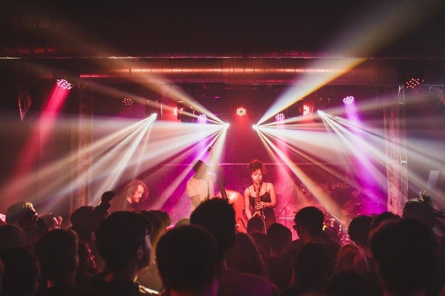 Vibrant live music event at XOYO with dynamic lighting and engaged audience.
