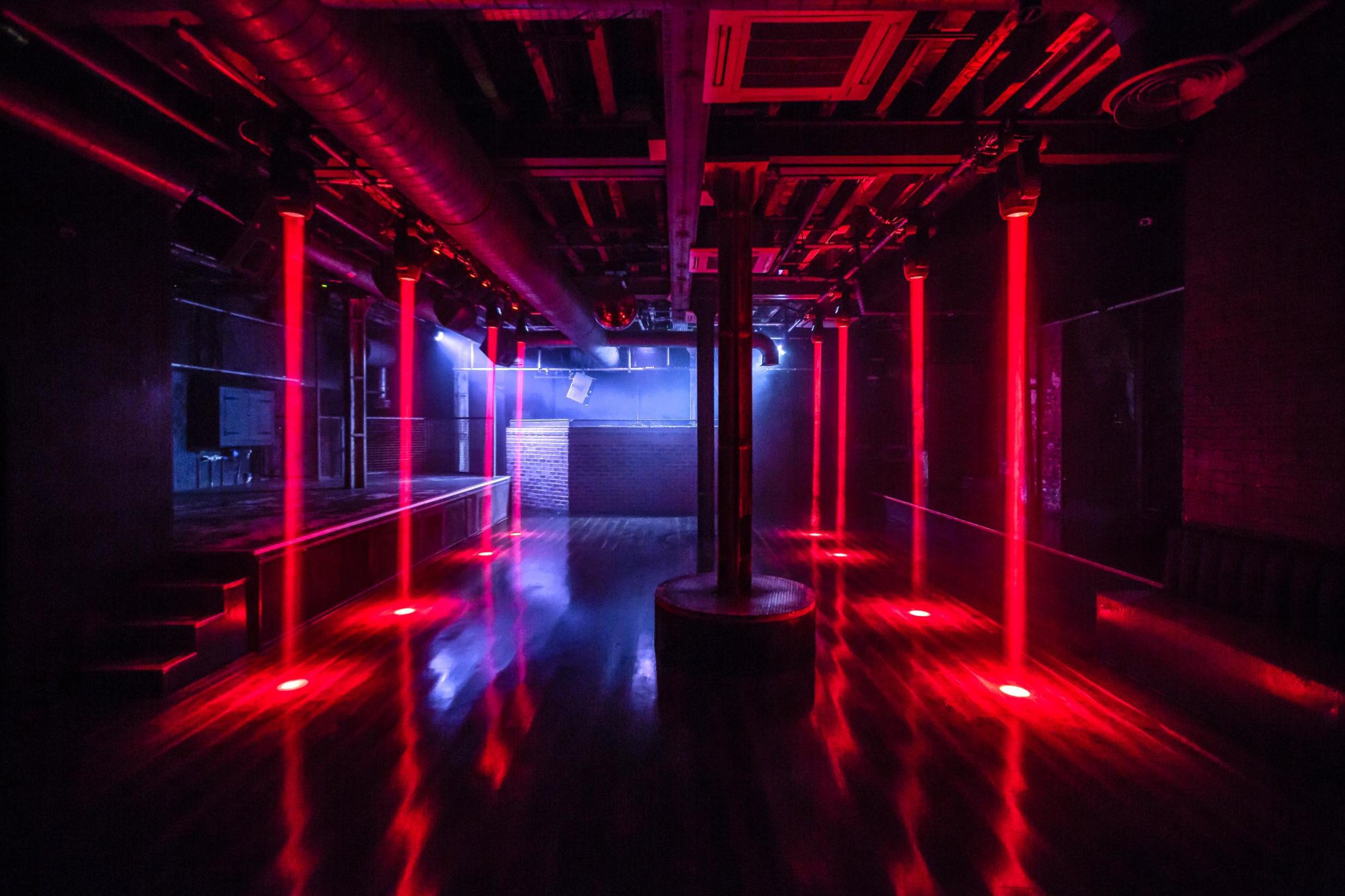 Sleek XOYO event space with red lighting, ideal for corporate and social gatherings.