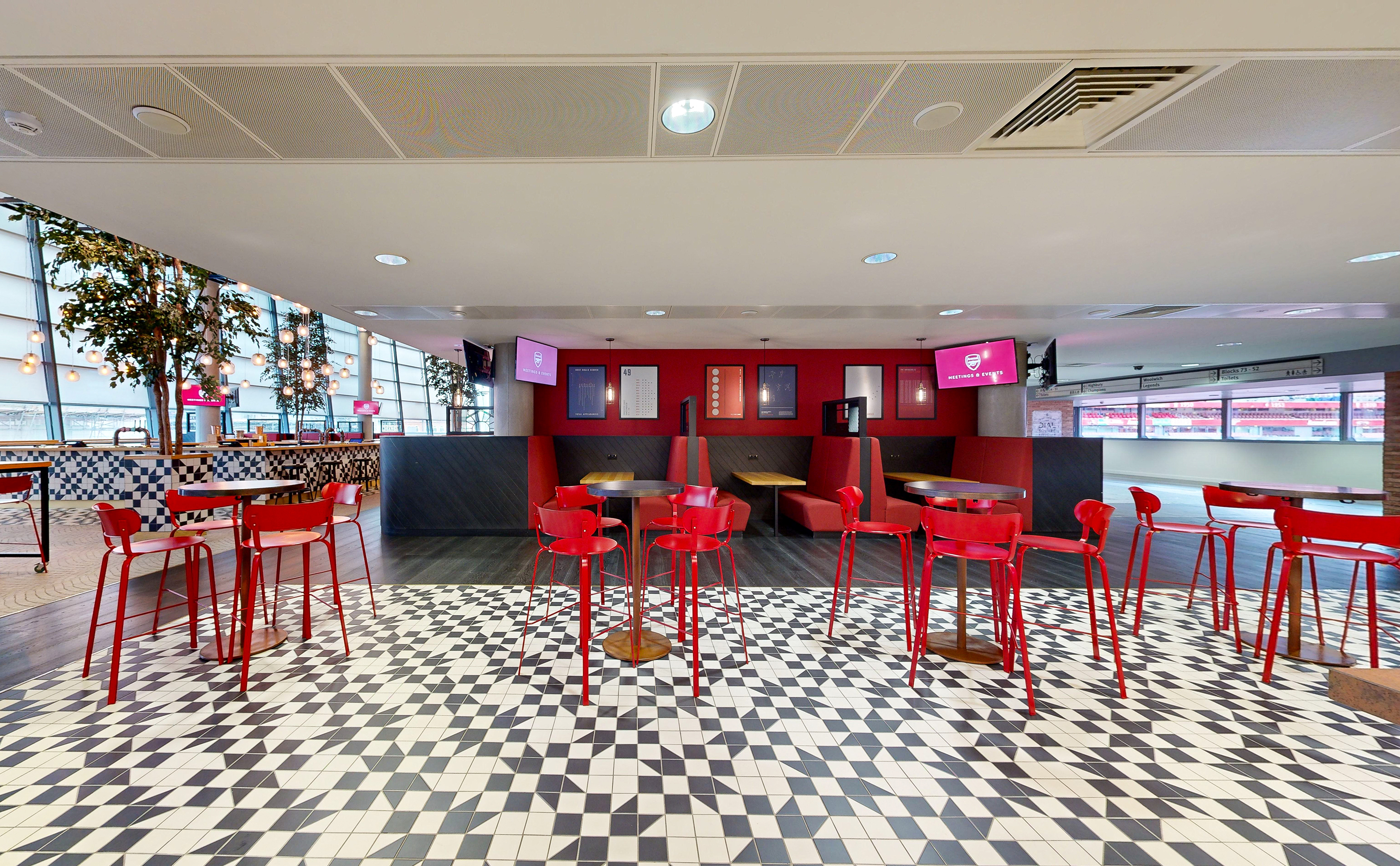 Dial Square at Emirates Stadium: modern event space with vibrant red furniture, ideal for receptions.