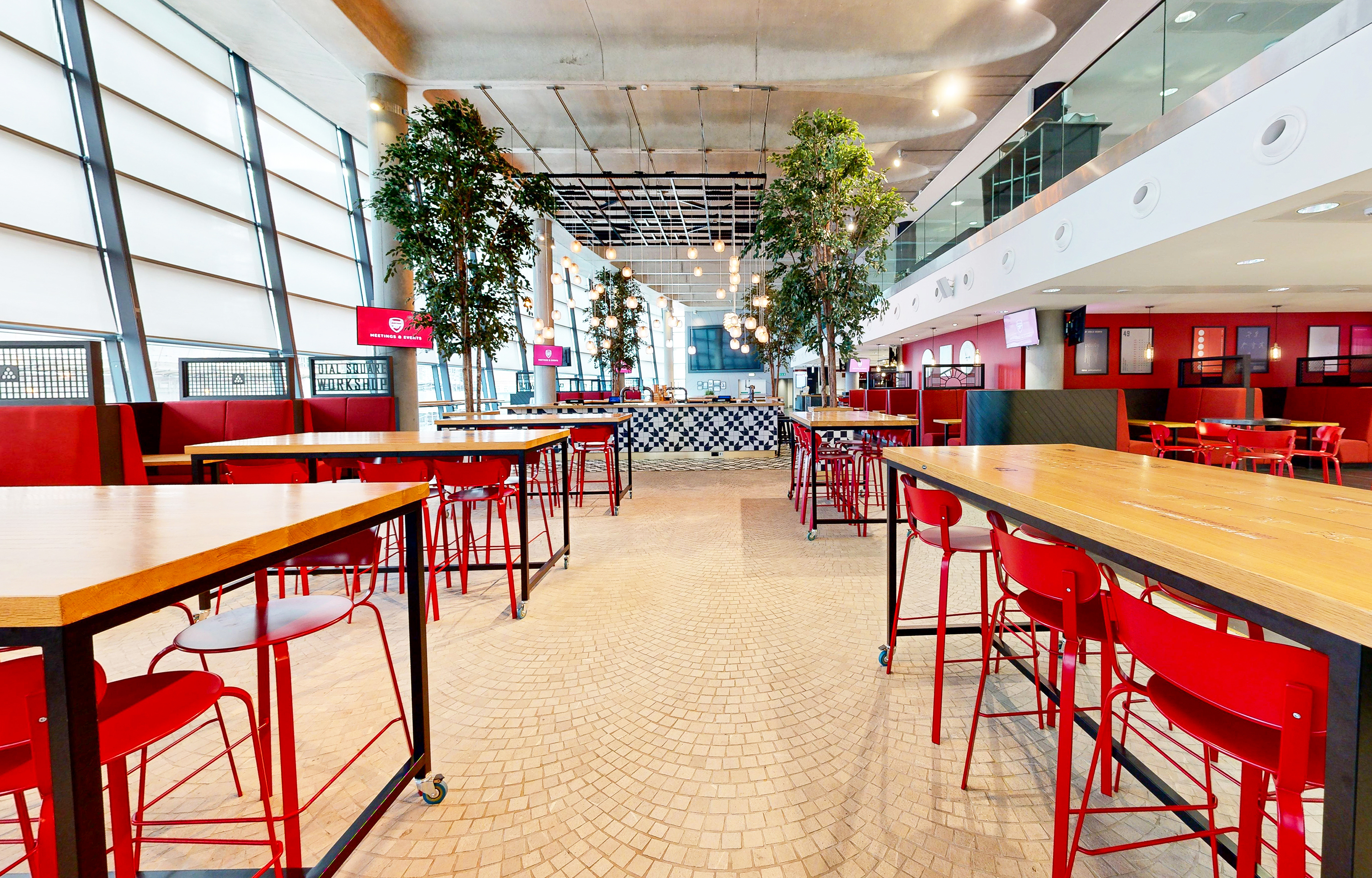 Dial Square at Emirates Stadium: modern event space with vibrant red chairs, ideal for networking.